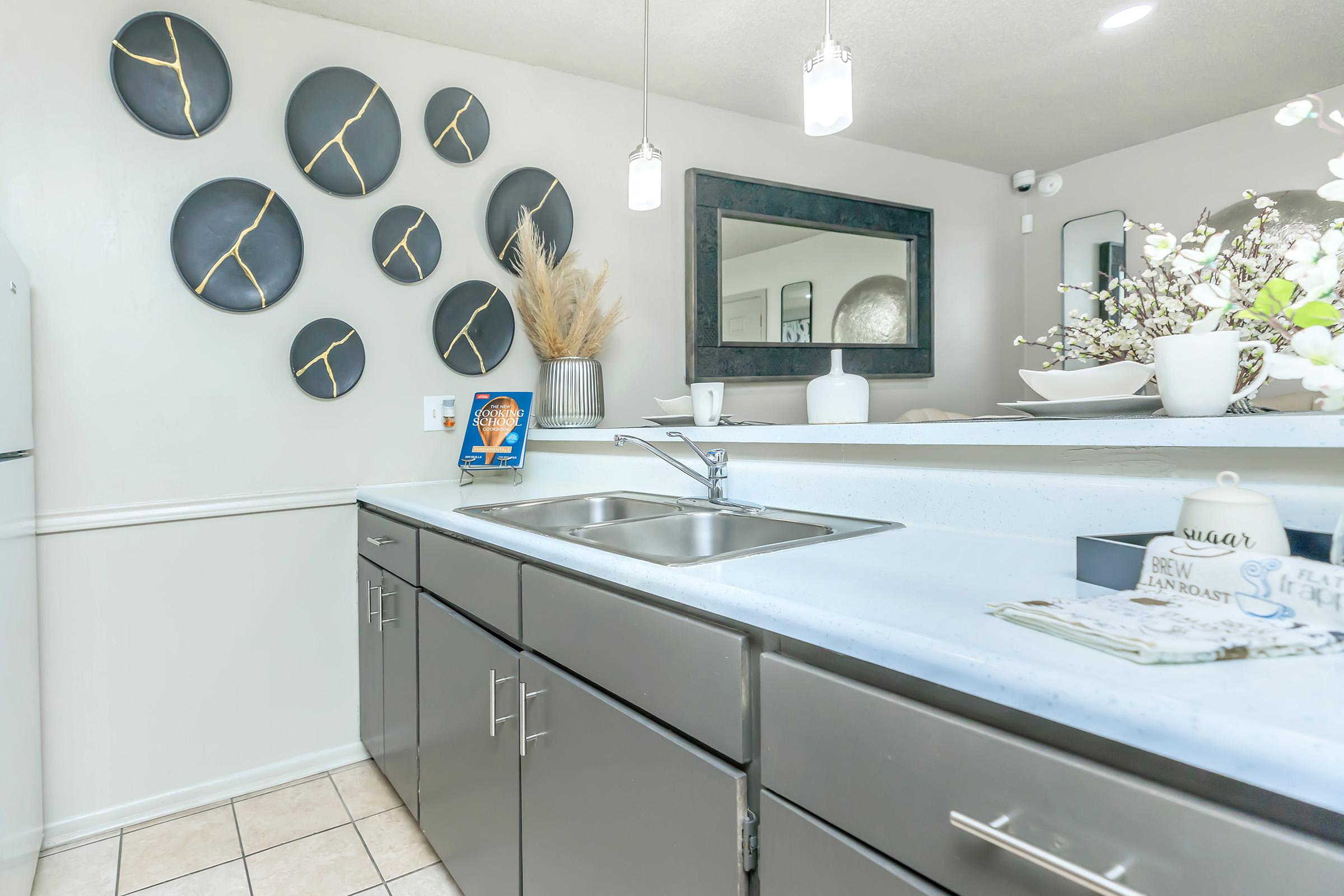 a kitchen with a sink and a mirror