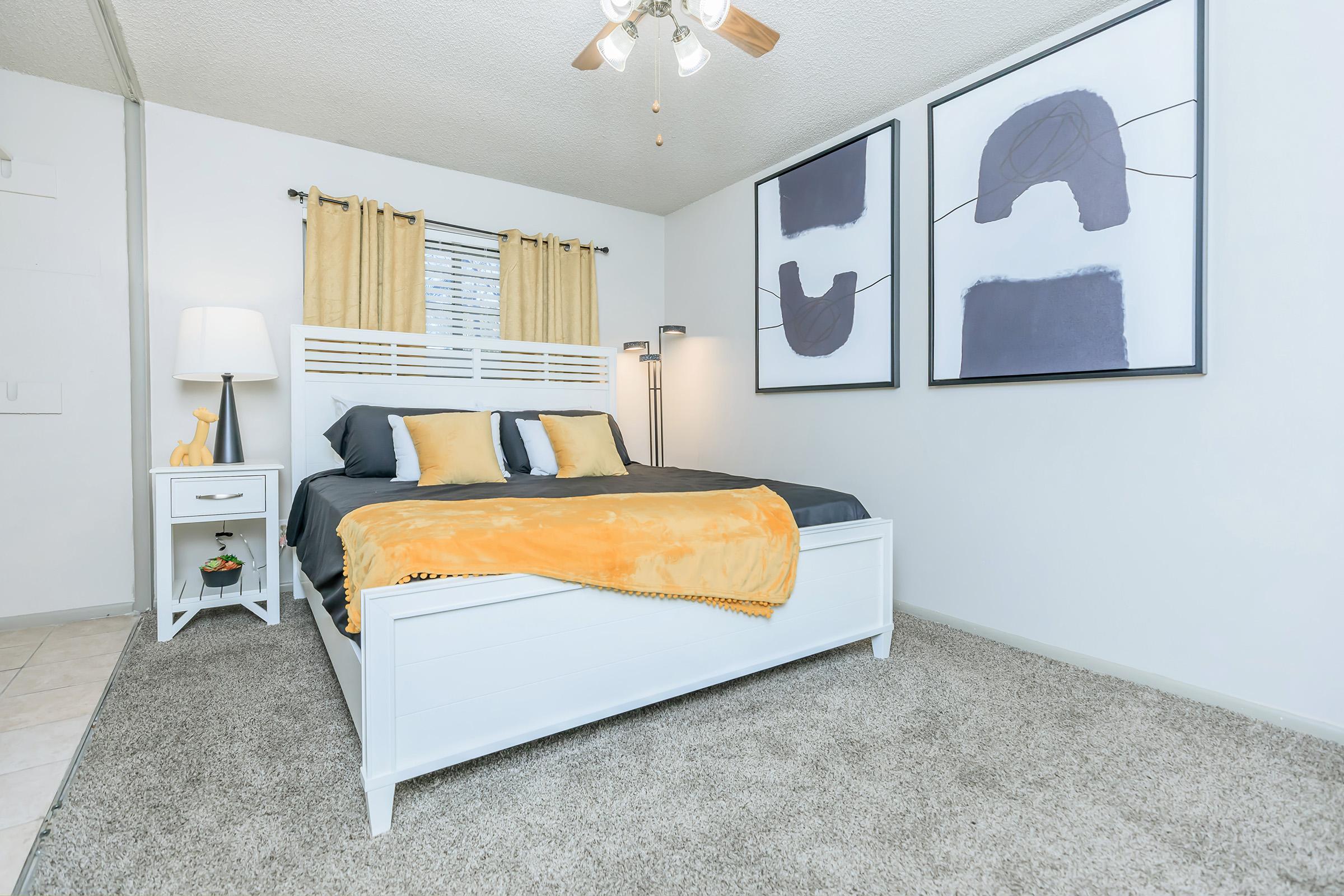 a bedroom with a bed and desk in a room