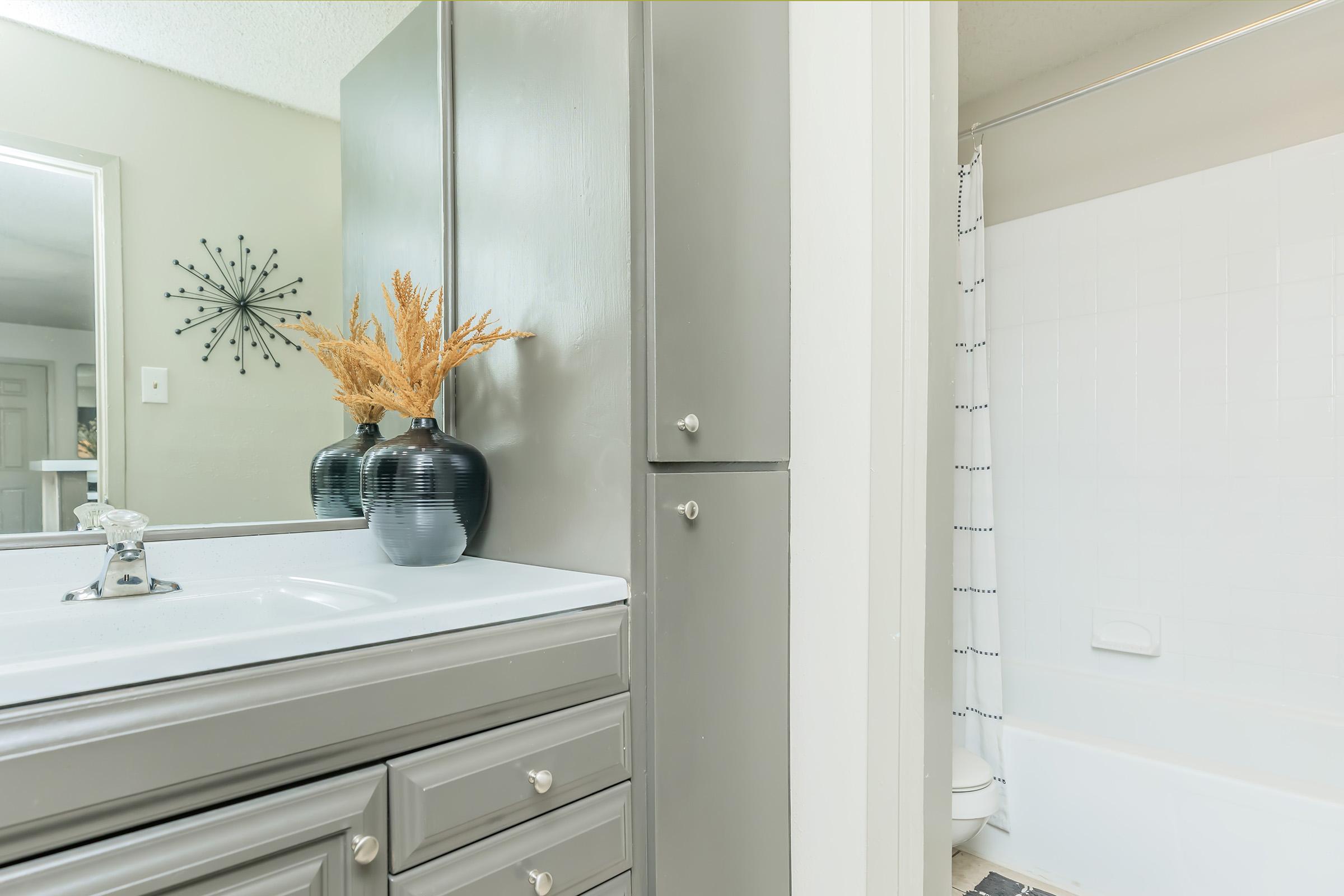 a room with a sink and a mirror