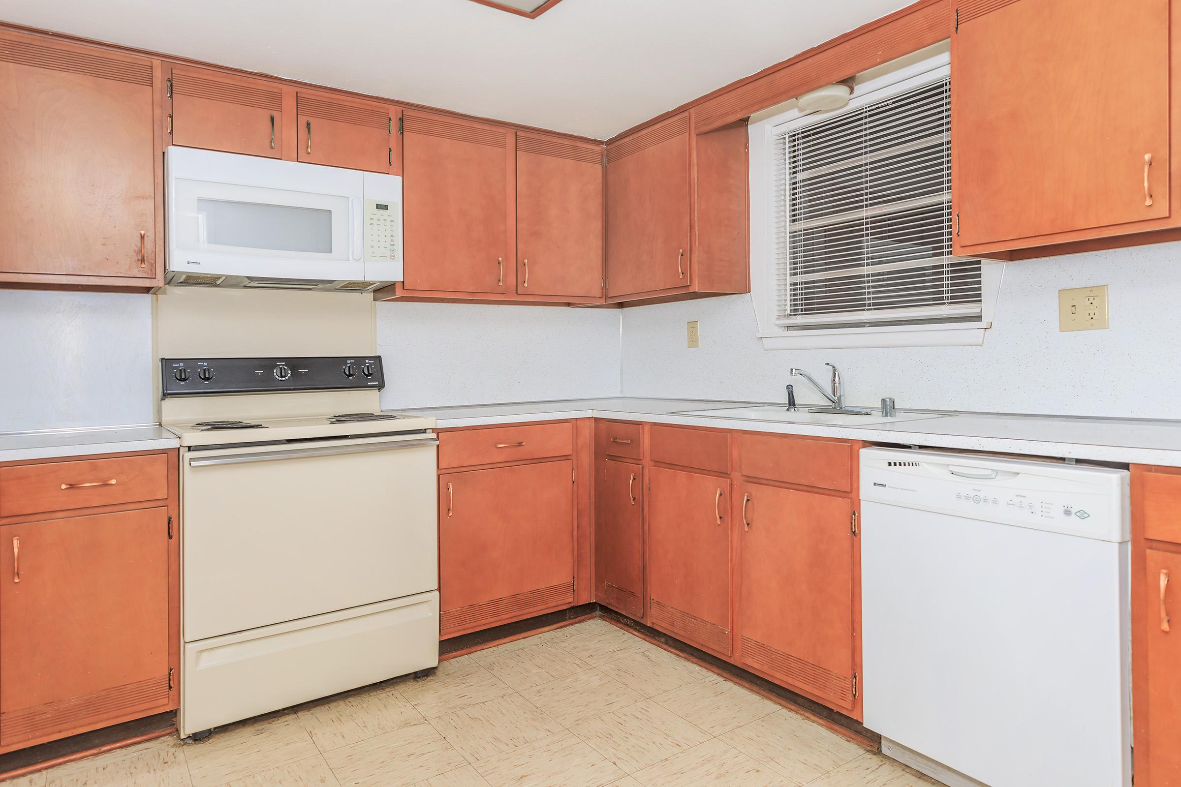 a kitchen with a stove and a refrigerator