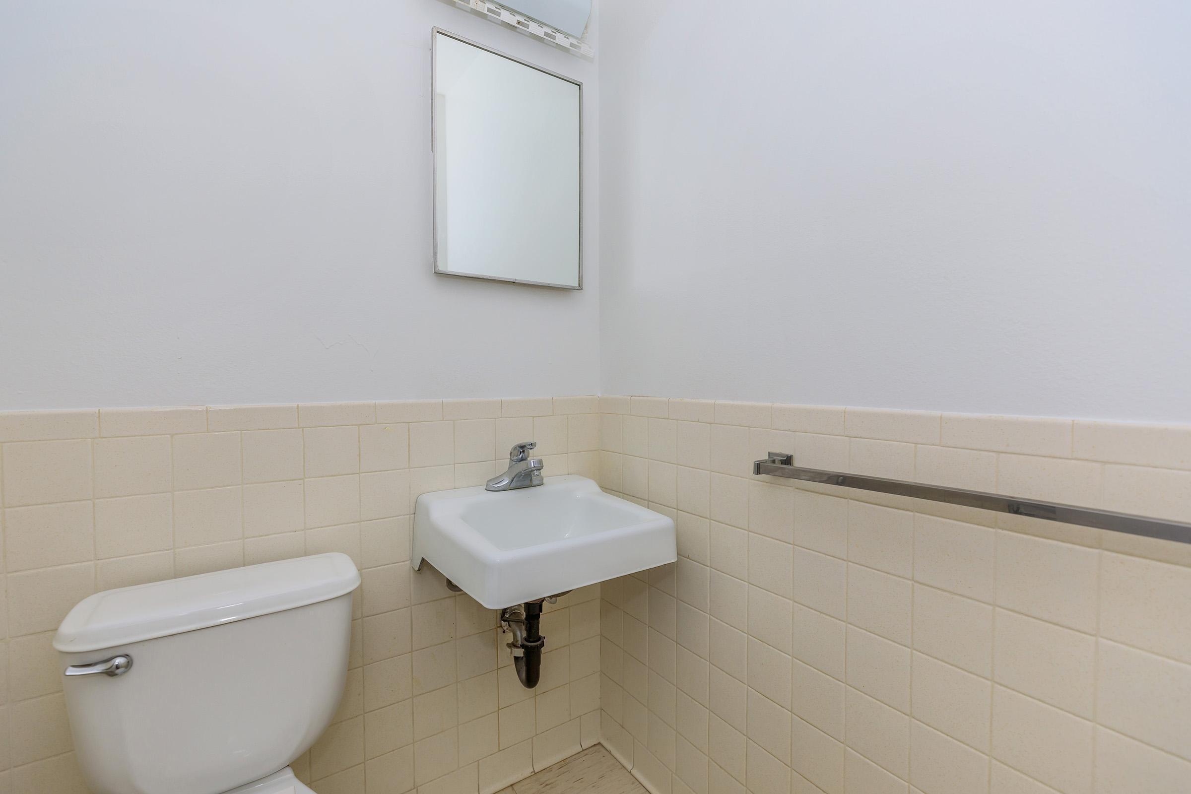 a restroom with a sink and a mirror