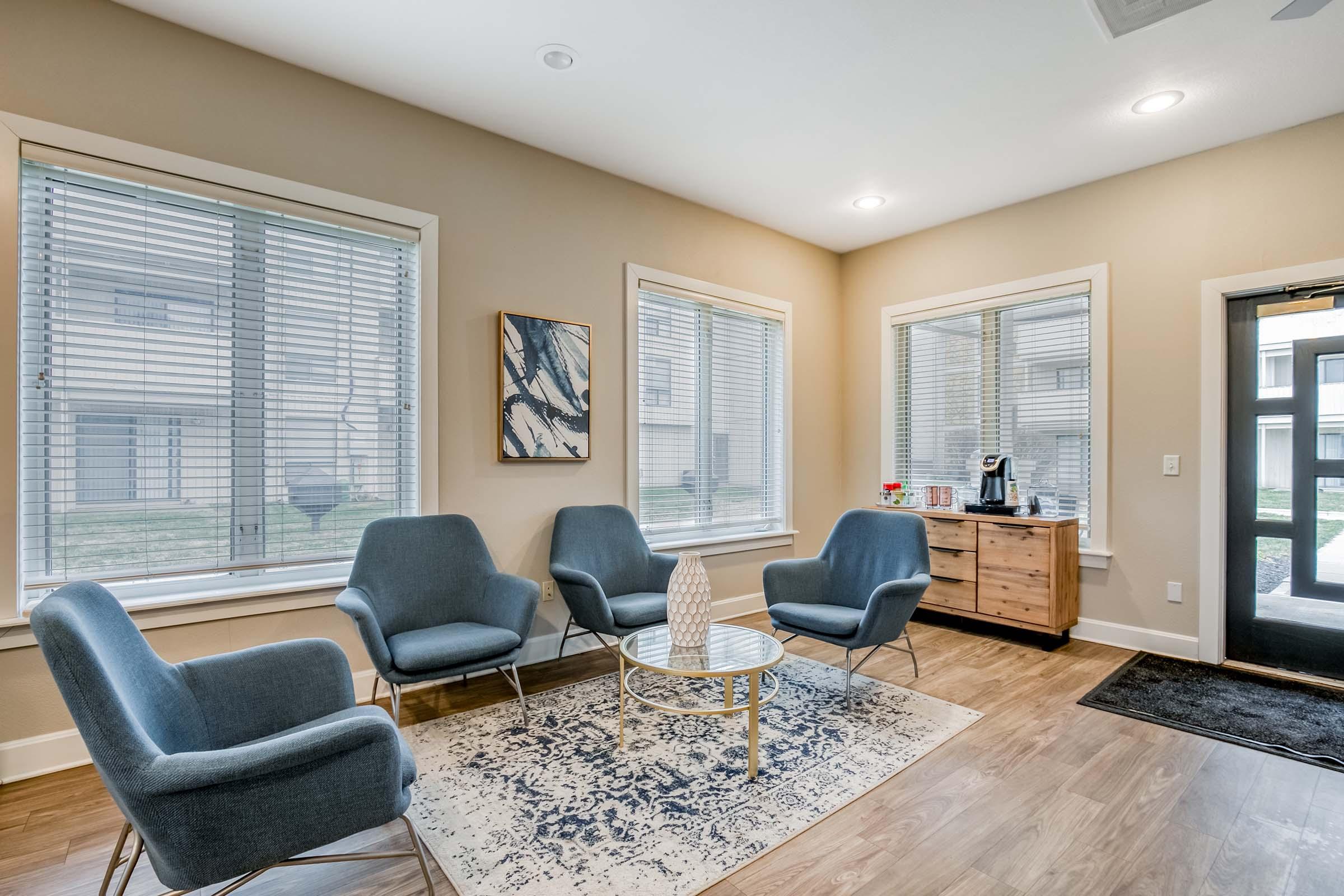 a living room filled with furniture and a large window