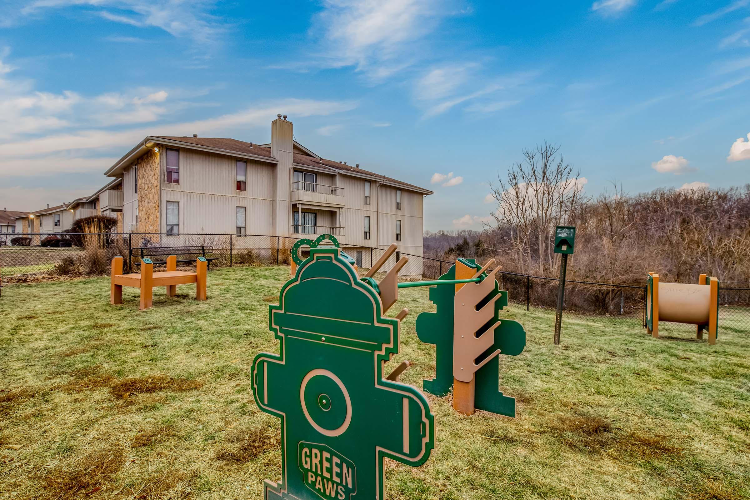 a house that has a sign on a grassy field