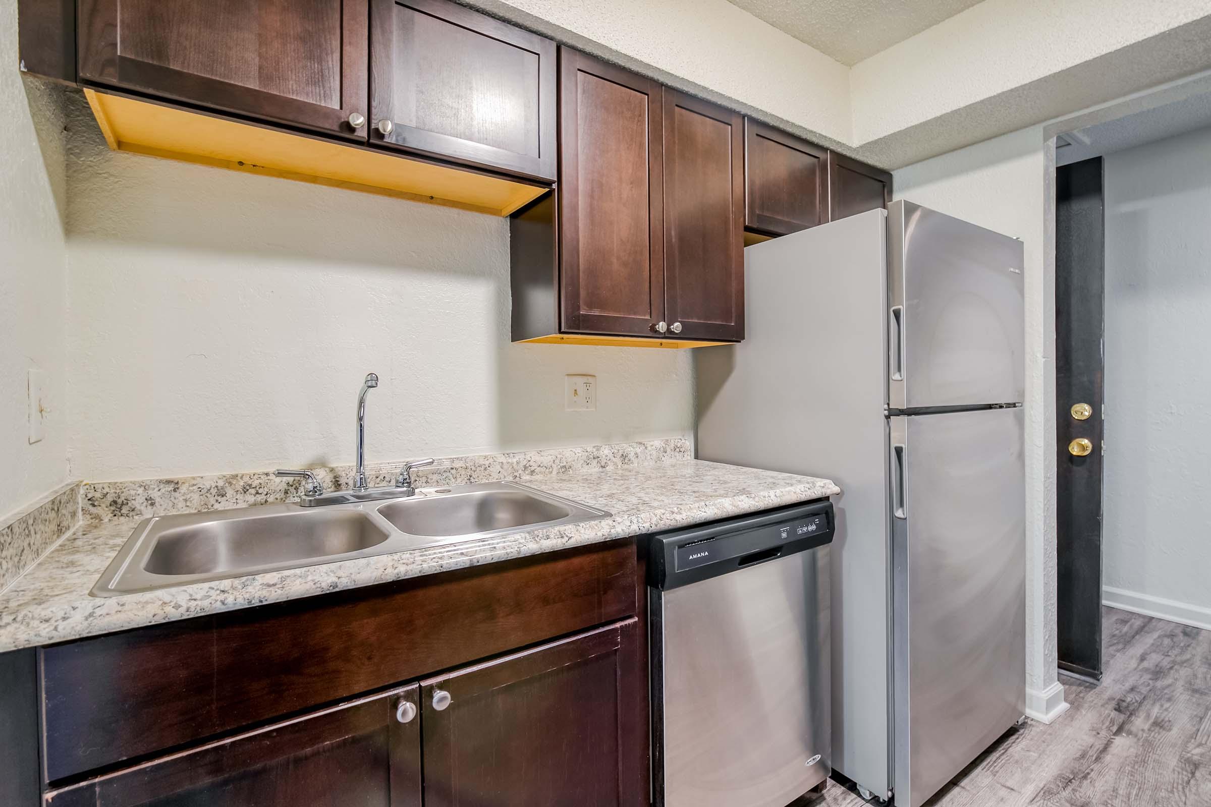 a kitchen with a sink and a mirror