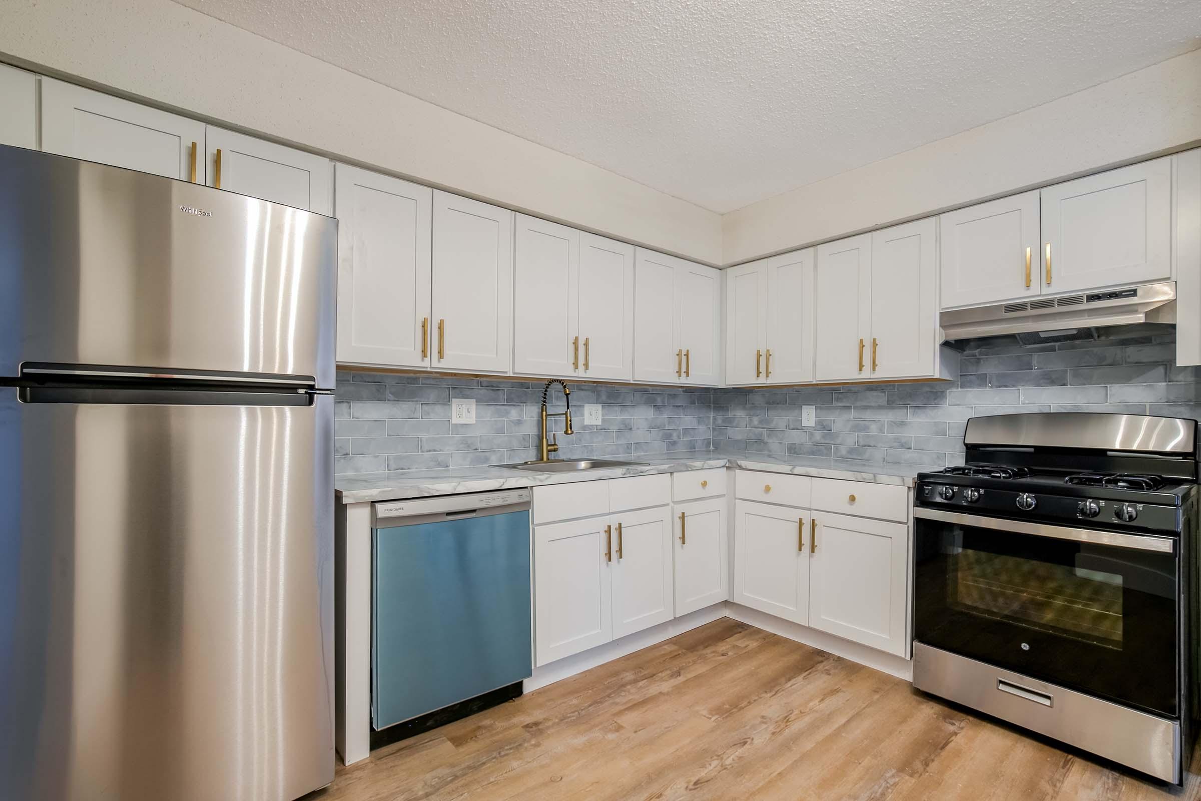 a kitchen with stainless steel appliances and wooden cabinets