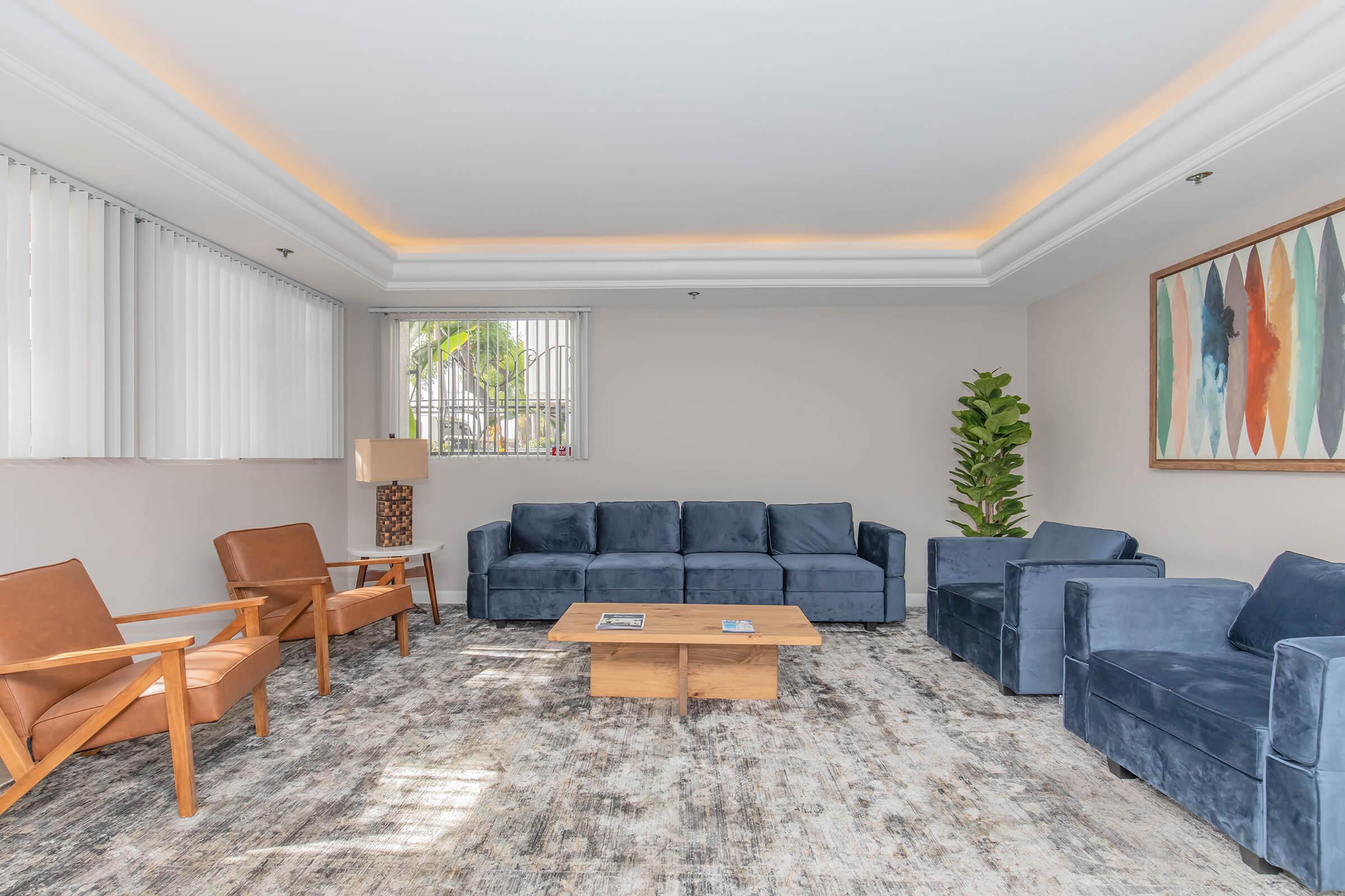 a living room filled with furniture and a large window