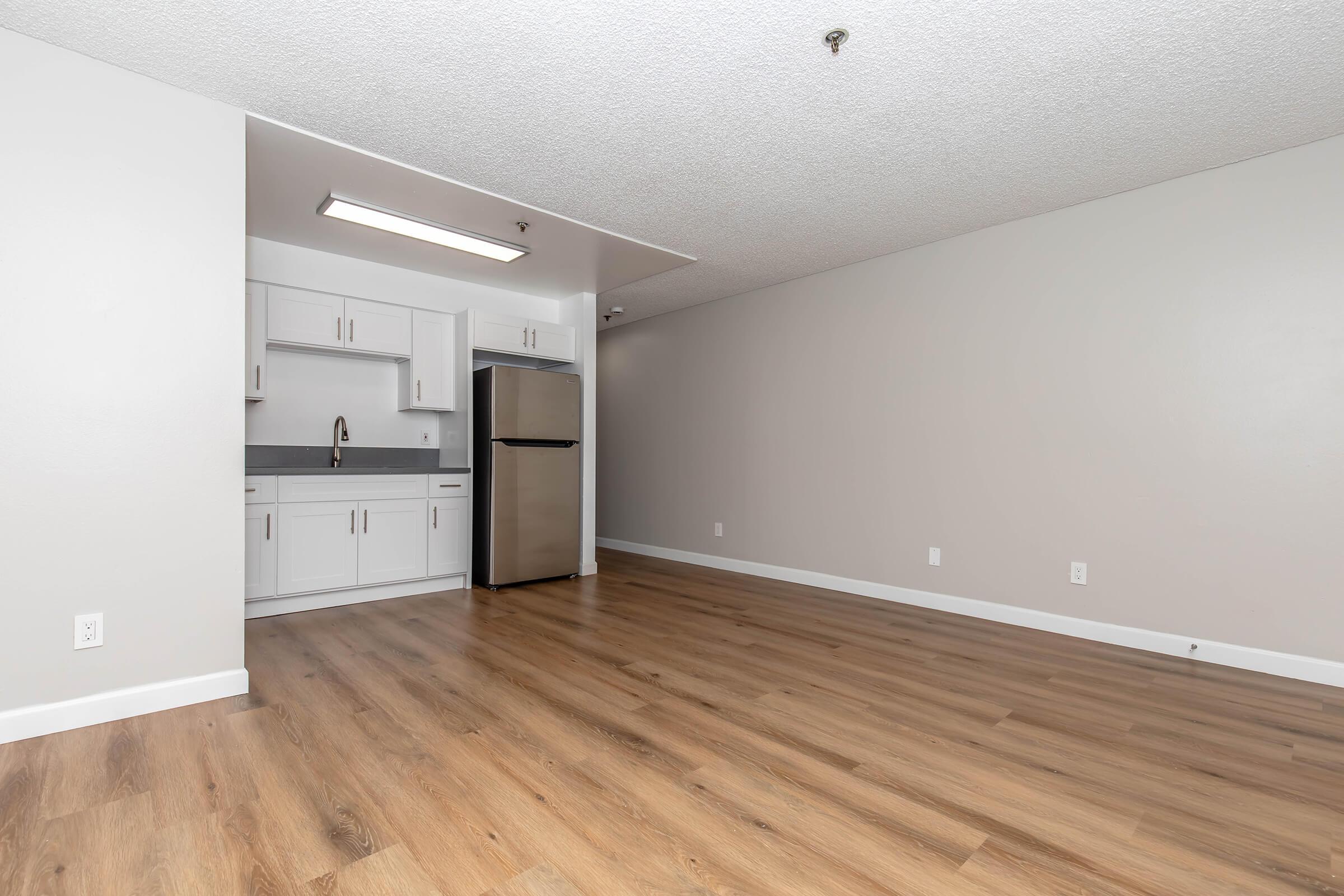 a large empty room with a wooden floor