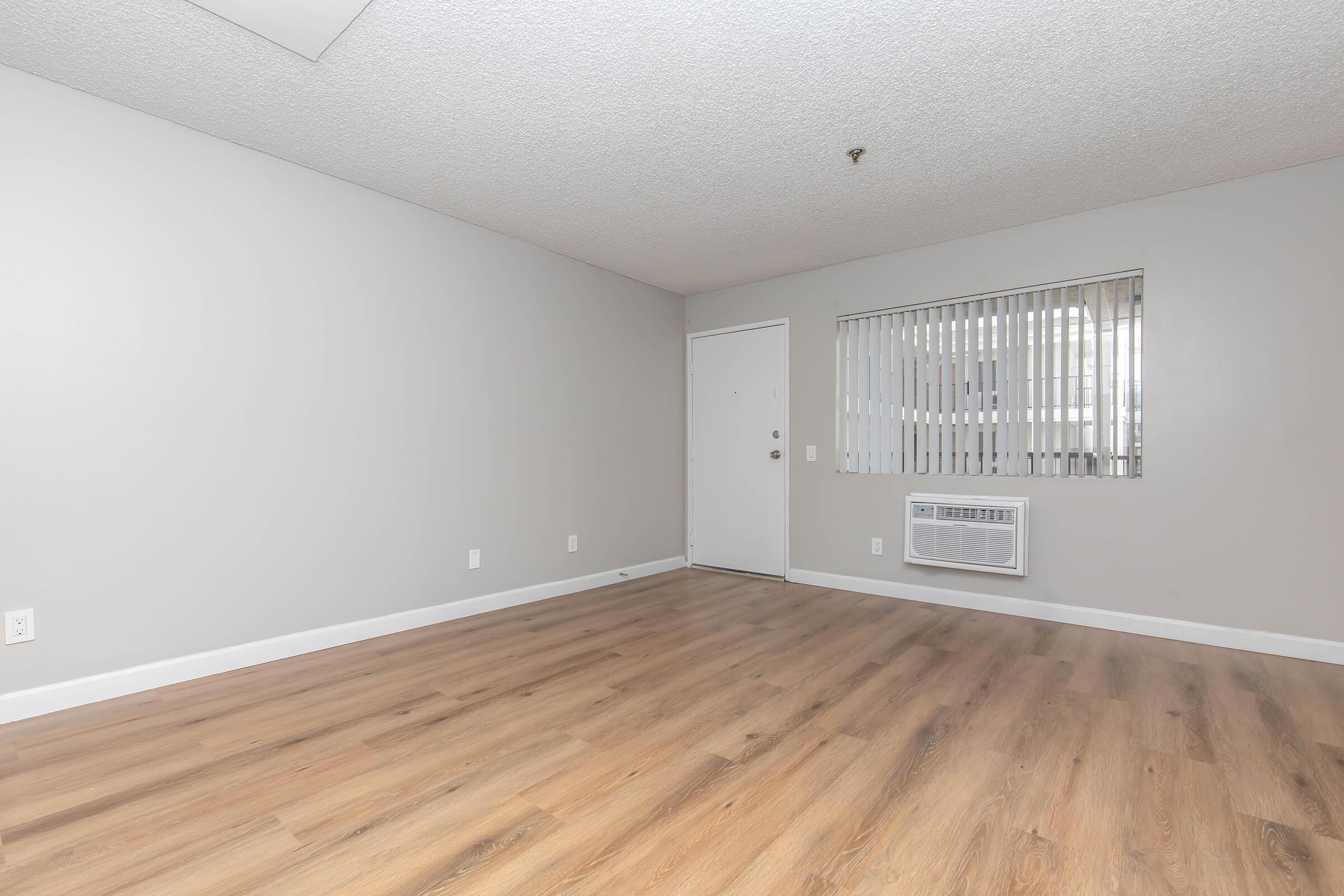 a large empty room with a wooden floor