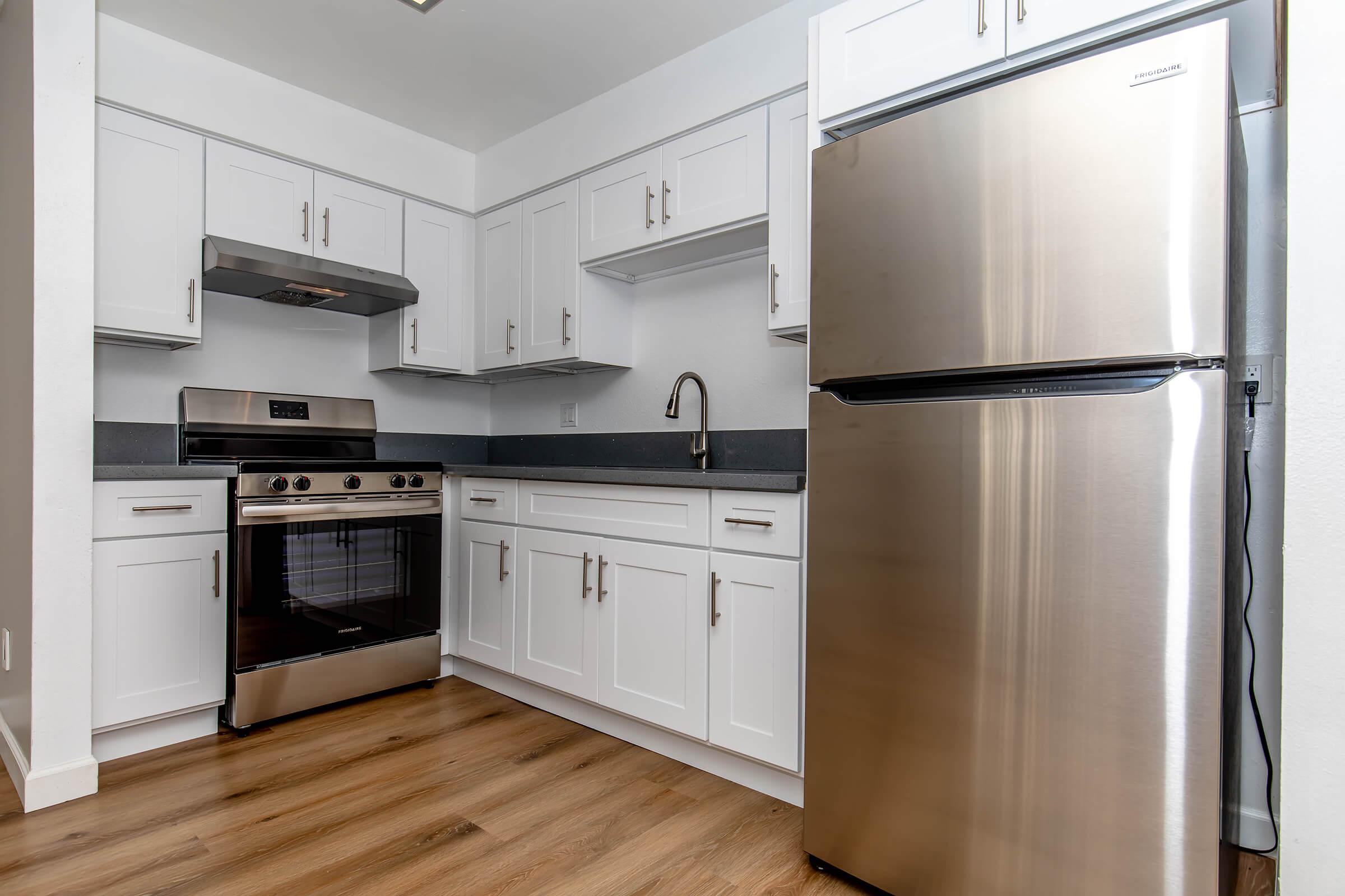 a kitchen with a stove and a refrigerator