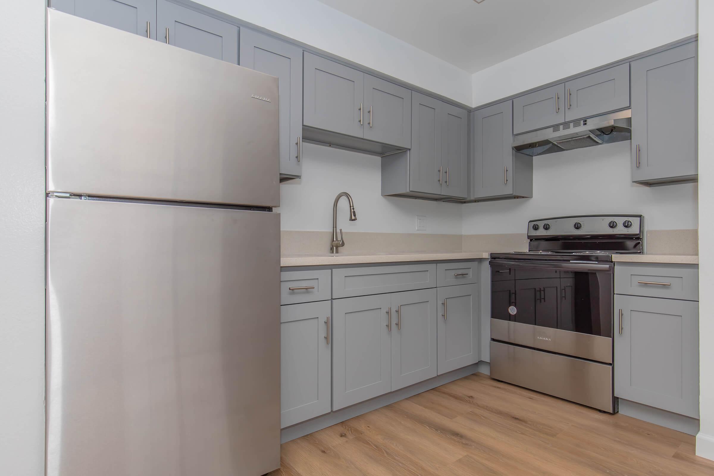 a kitchen with a stove and a refrigerator