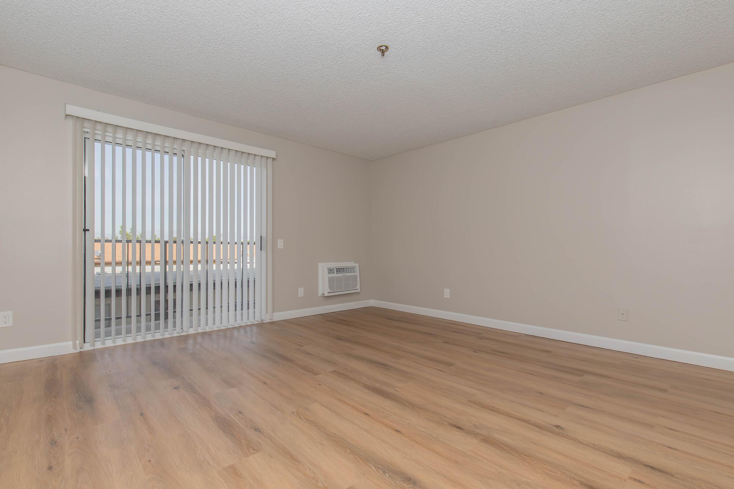 a large empty room with a wood floor