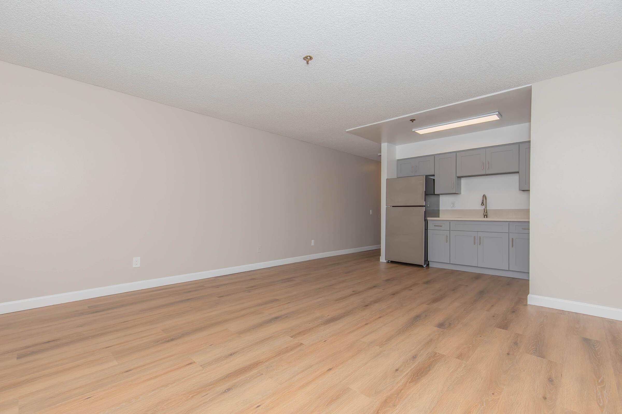 a large empty room with a wooden floor