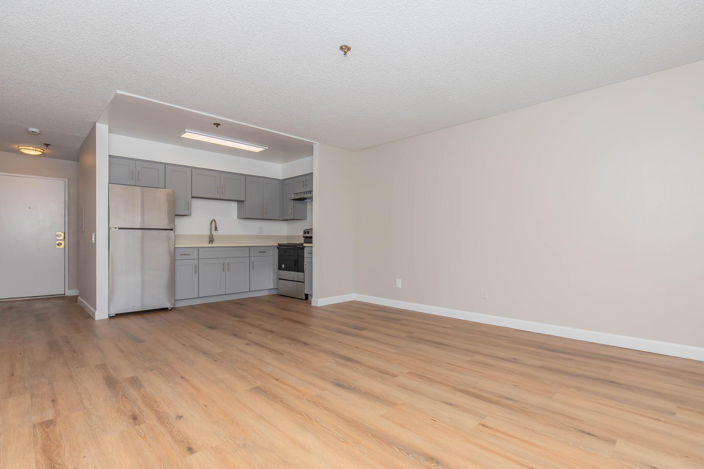 a large empty room with a wood floor