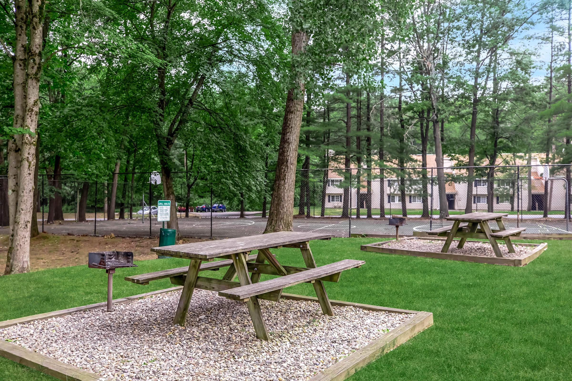 a group of lawn chairs sitting on top of a wooden bench