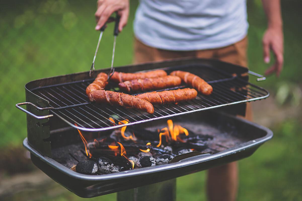 a person cooking food on a grill