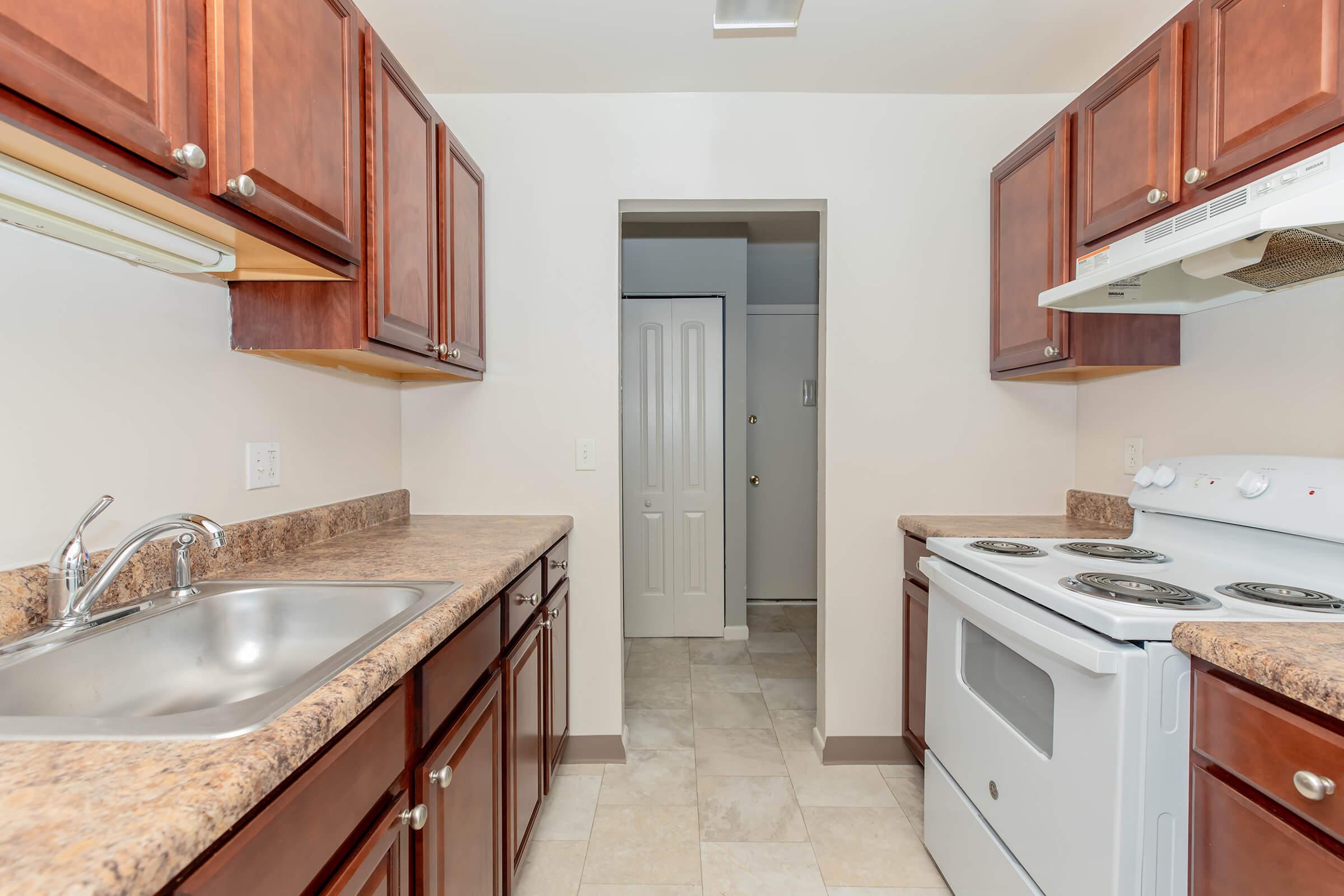 a kitchen with a sink and a mirror