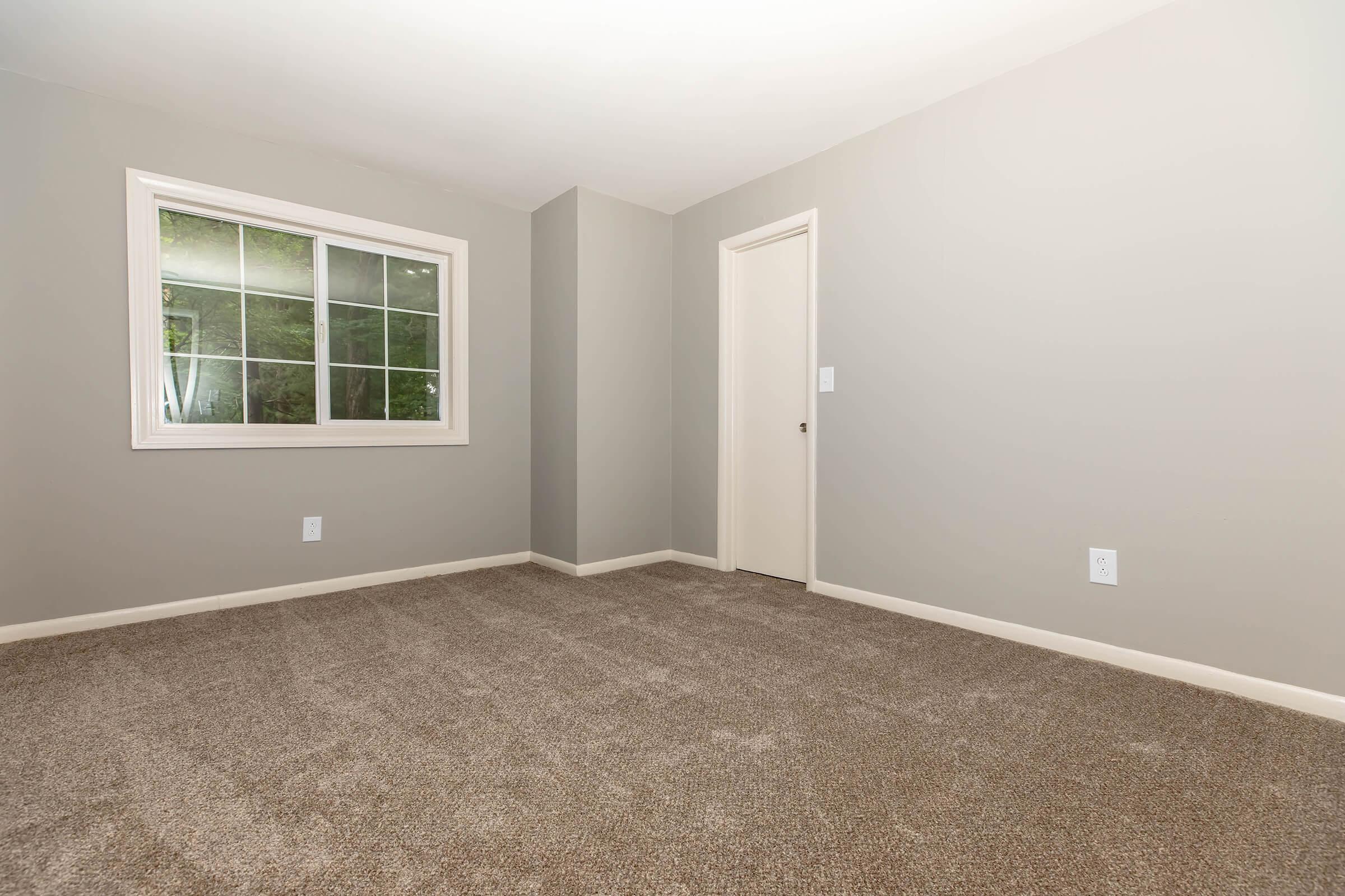 a bedroom with a large window