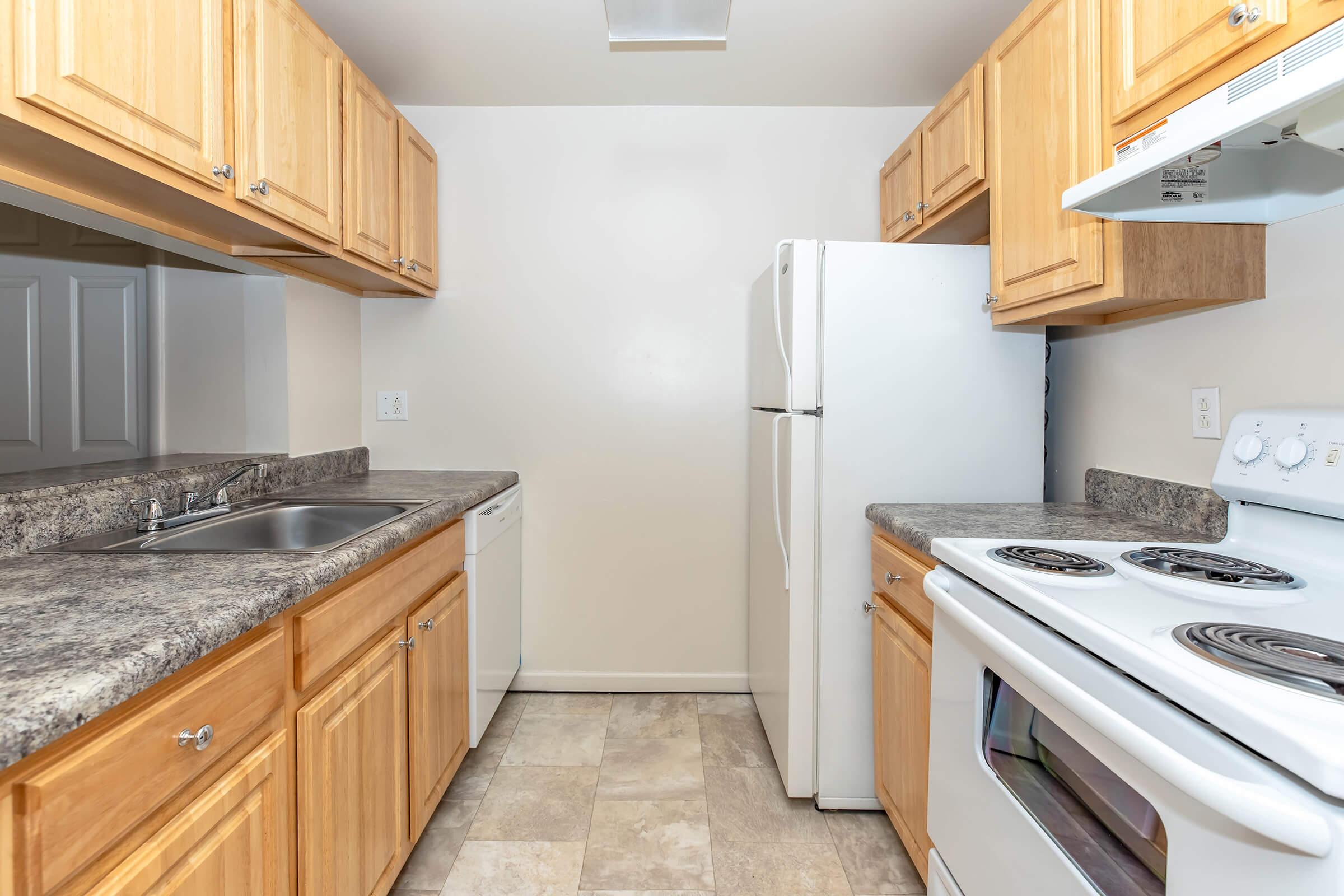 a kitchen with a stove sink and refrigerator