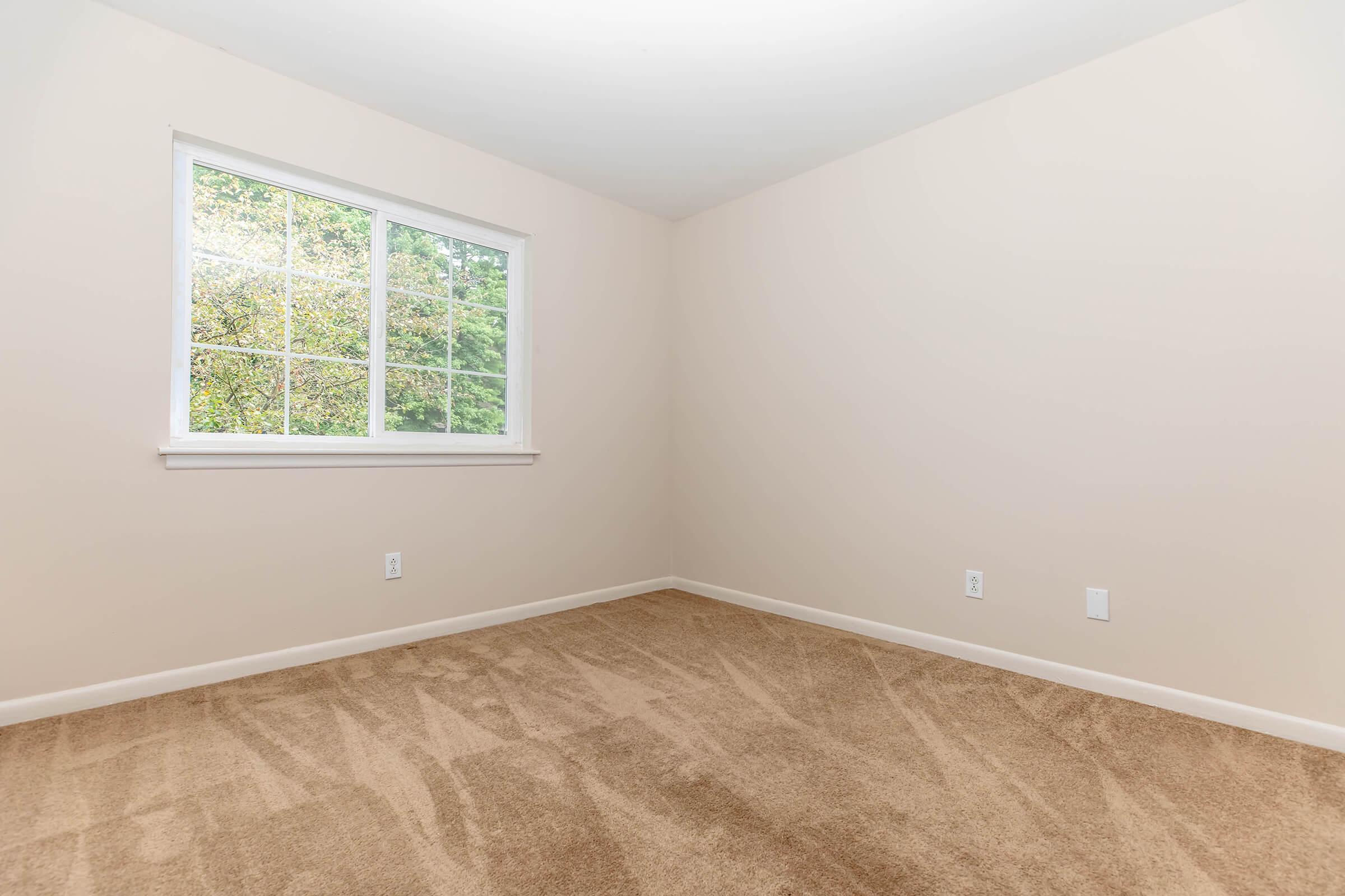 a bedroom with a large window