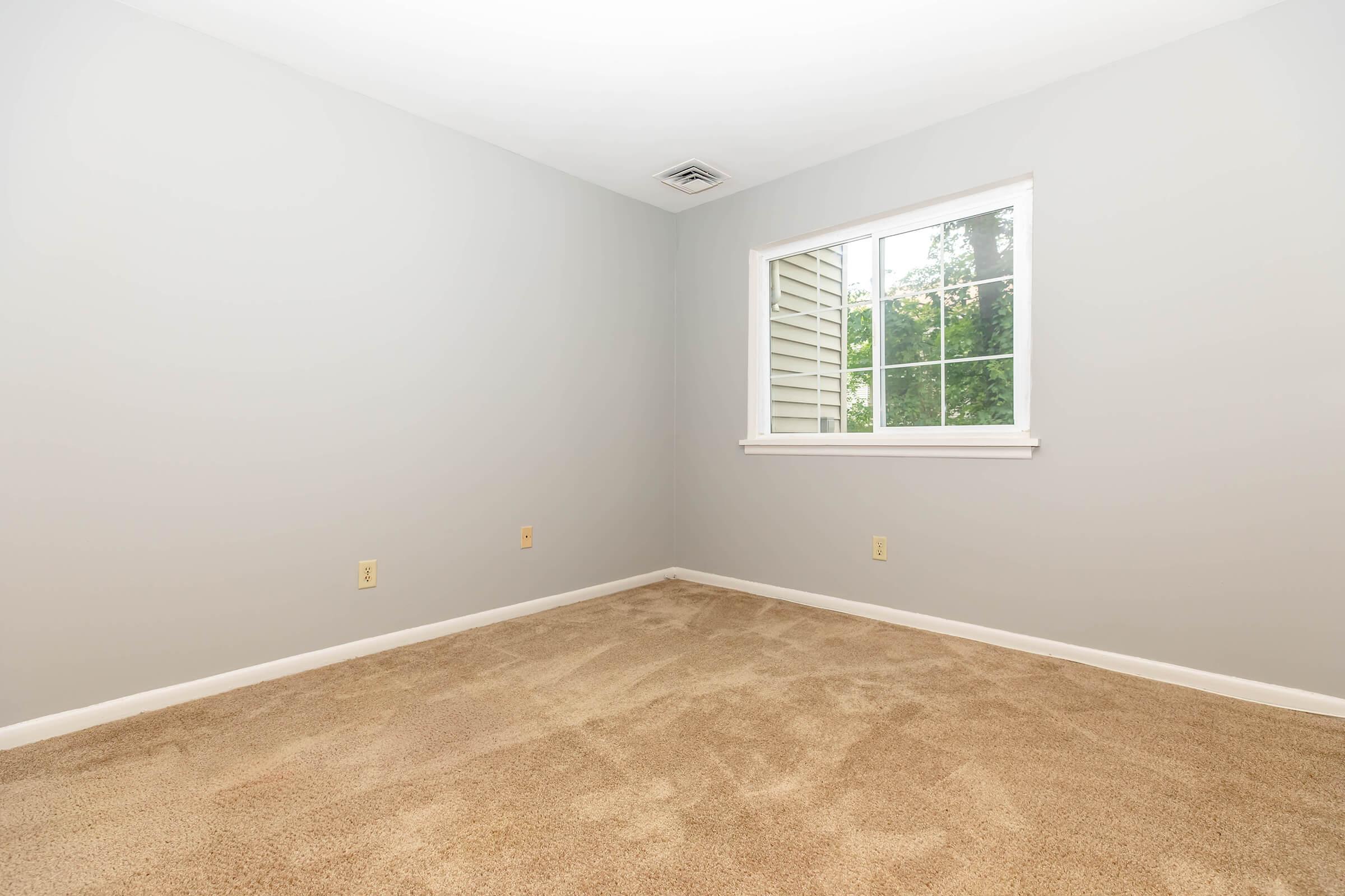 a bedroom with a large window