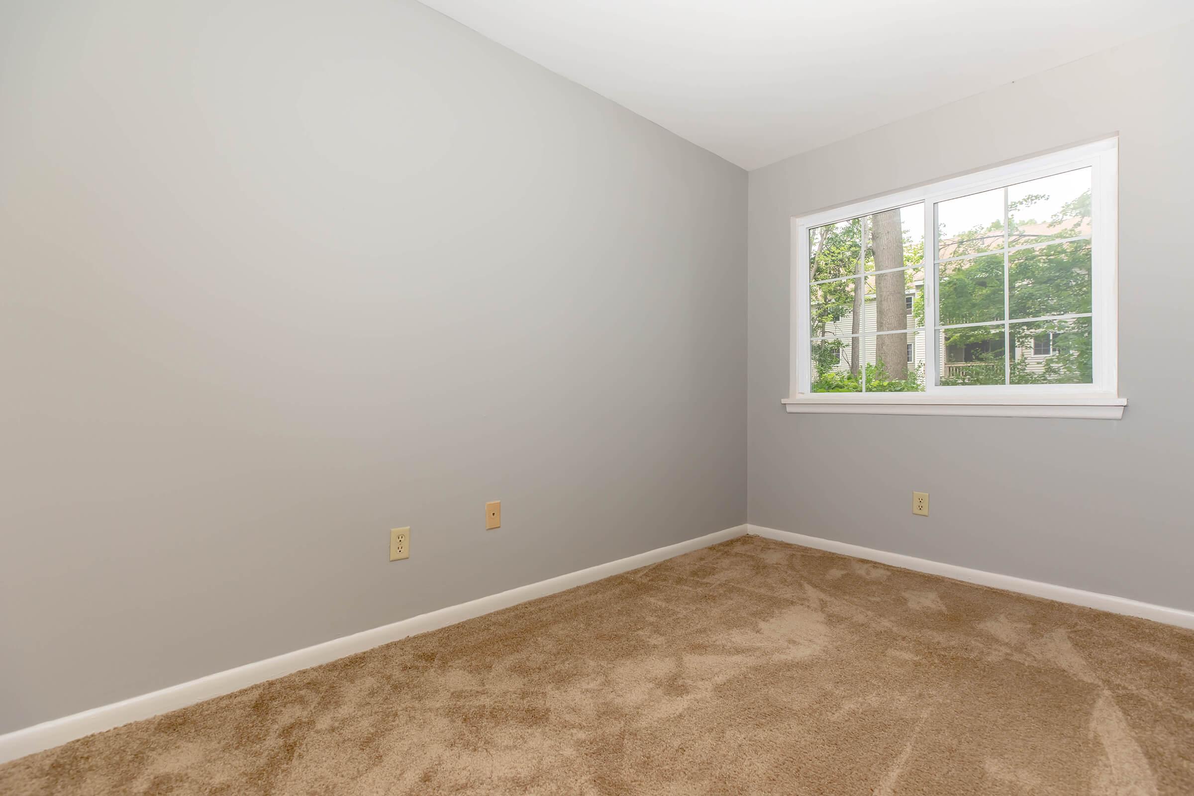 a bedroom with a large window