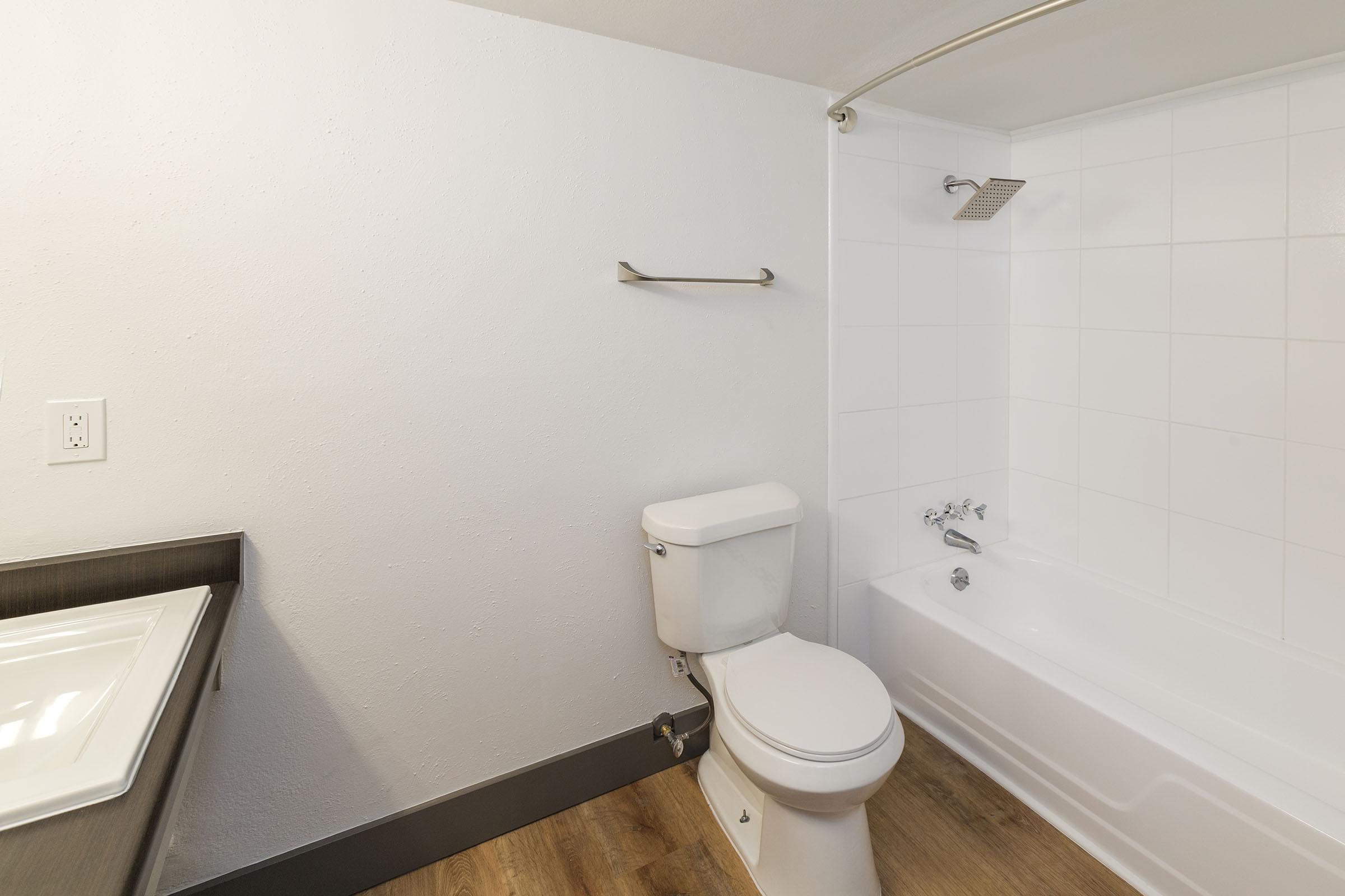 a white tub sitting next to a sink