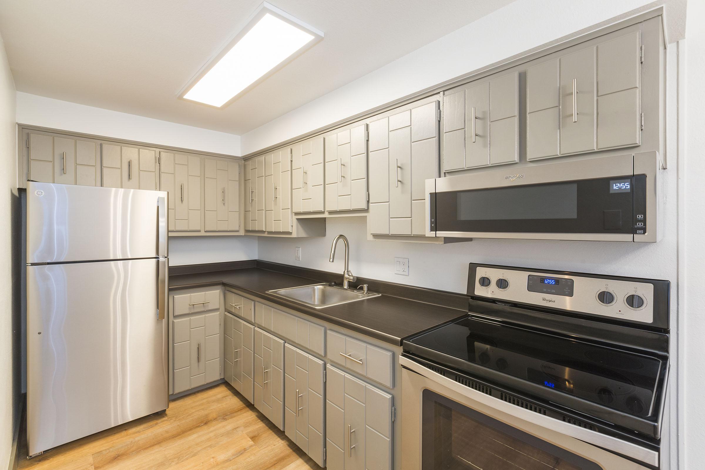 a kitchen with a stove and a refrigerator