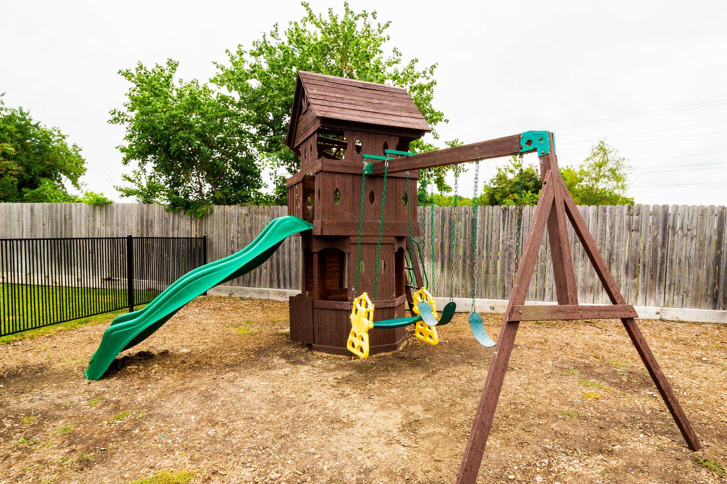 a playground in front of a fence