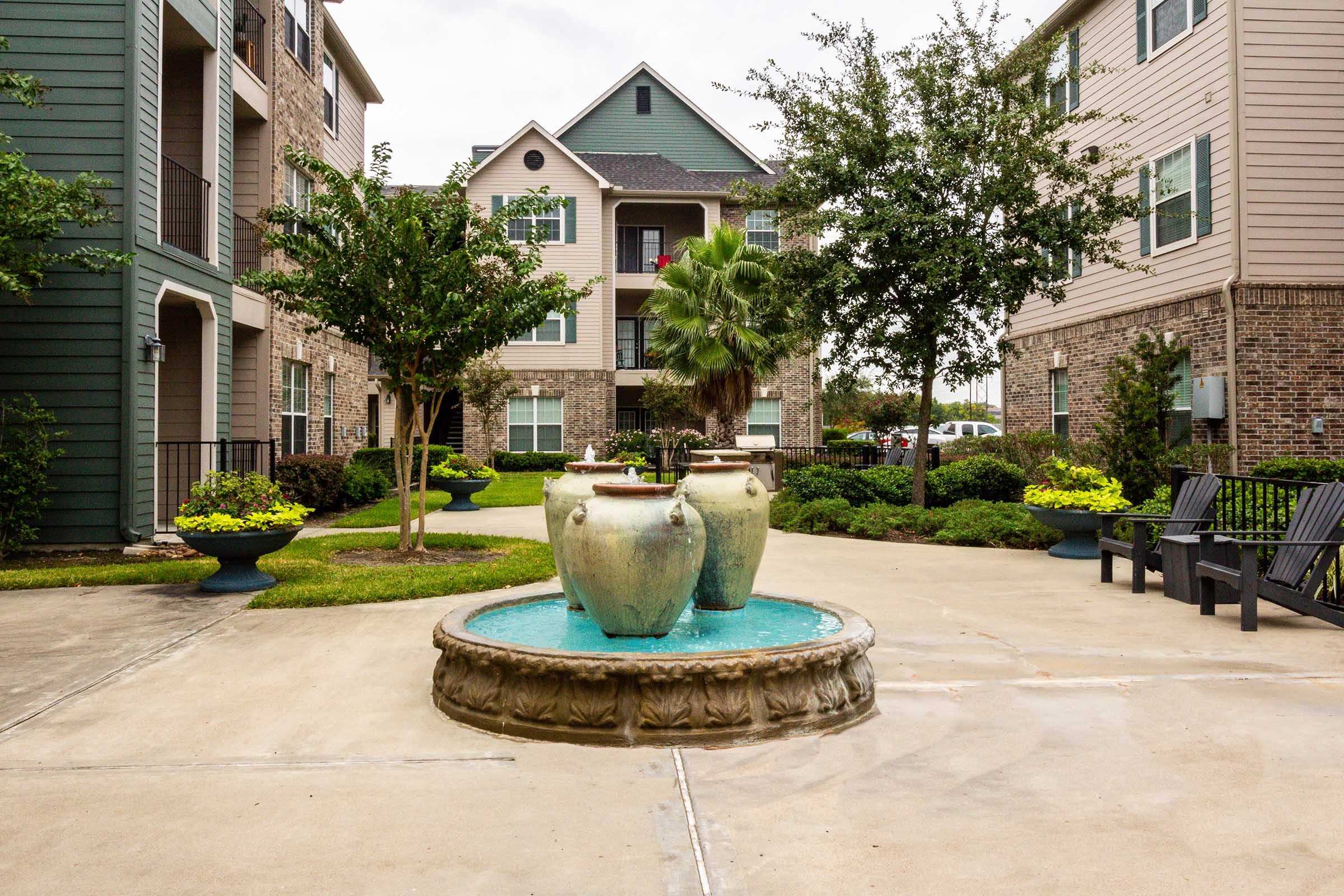 a large stone statue in front of a house