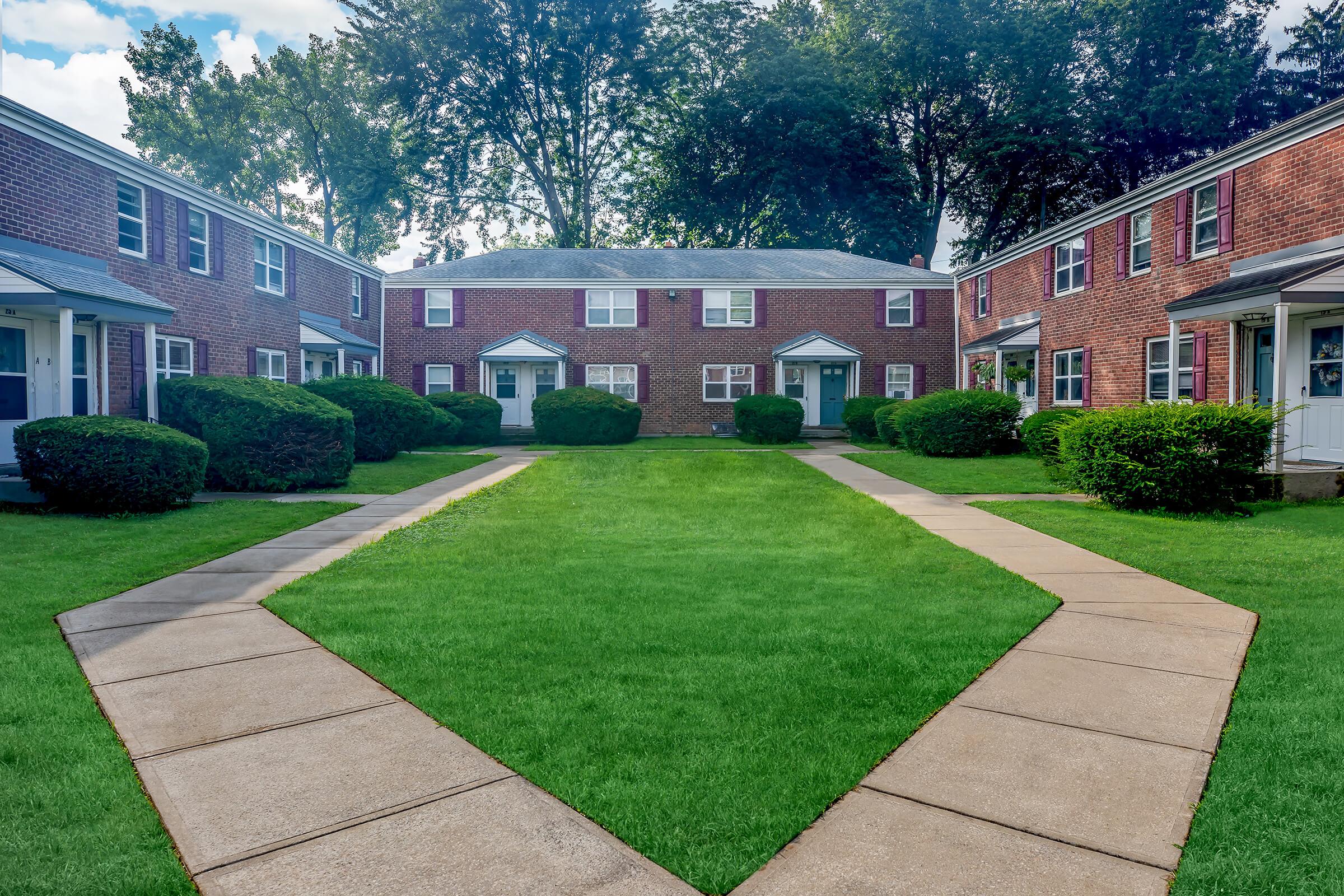 a large lawn in front of a brick building