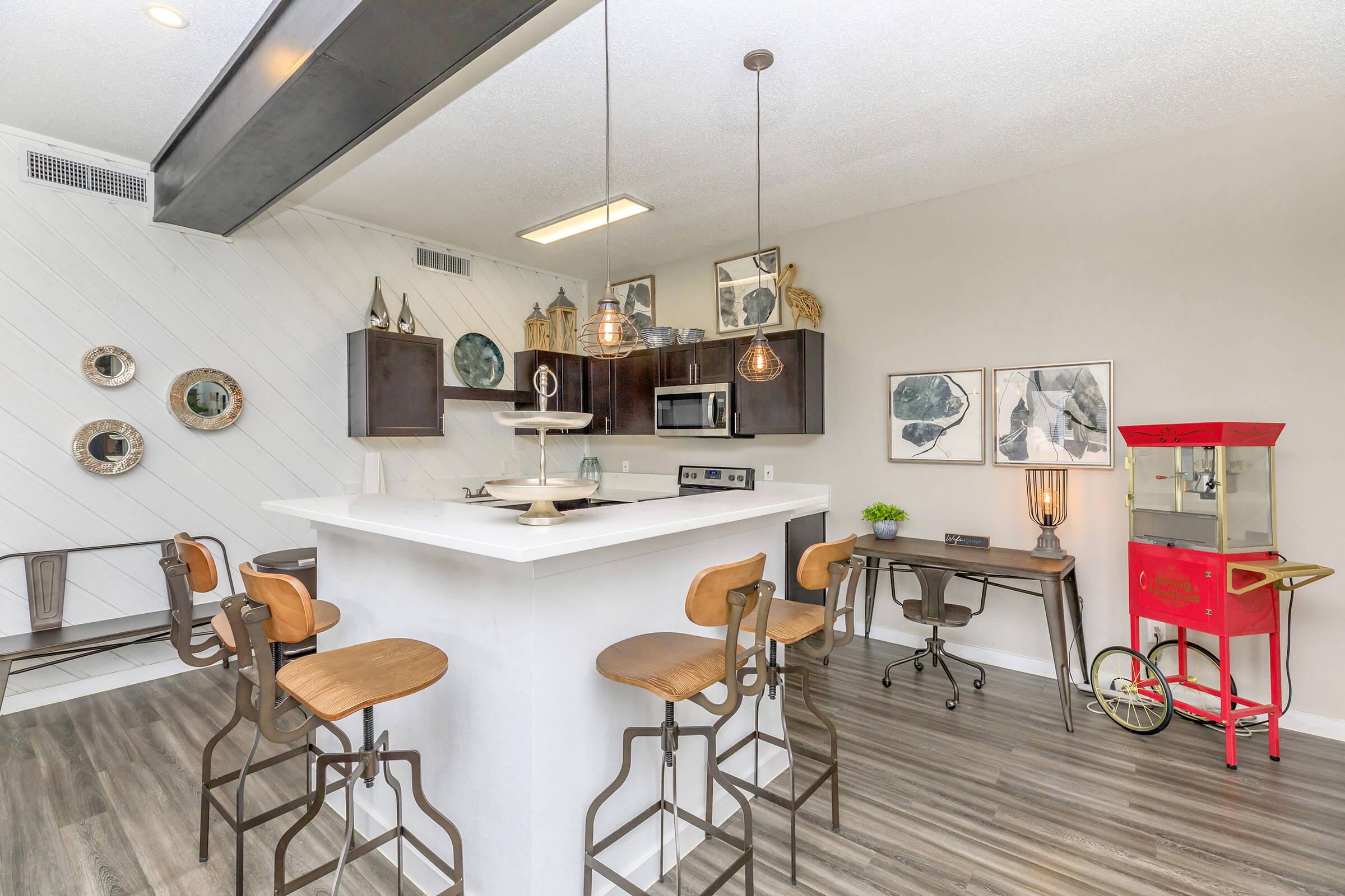 a kitchen with a table and chairs in a room