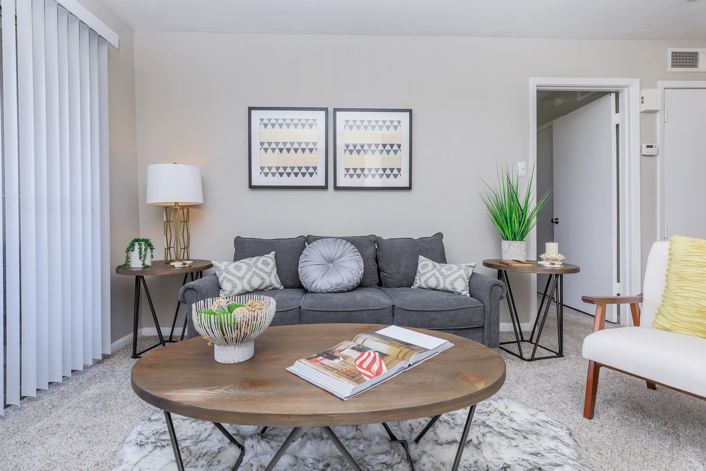 a living room filled with furniture and a fireplace