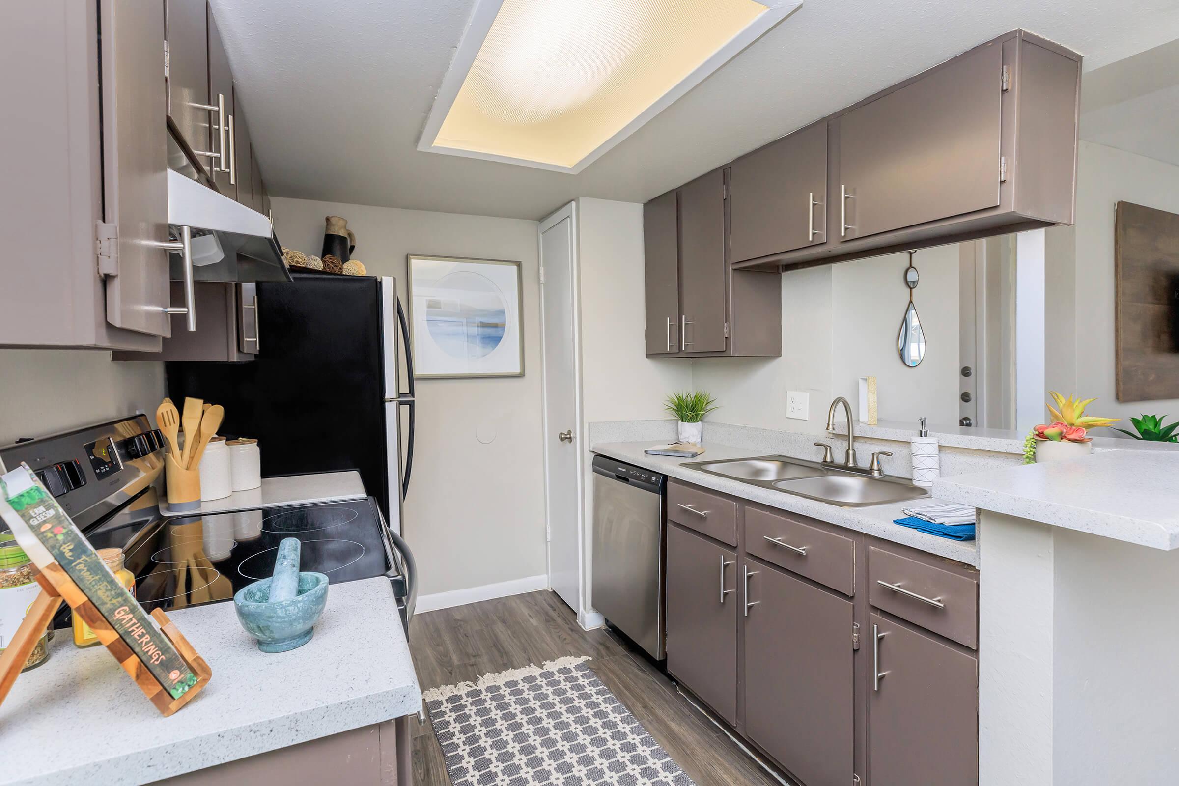 a kitchen with a sink and a mirror