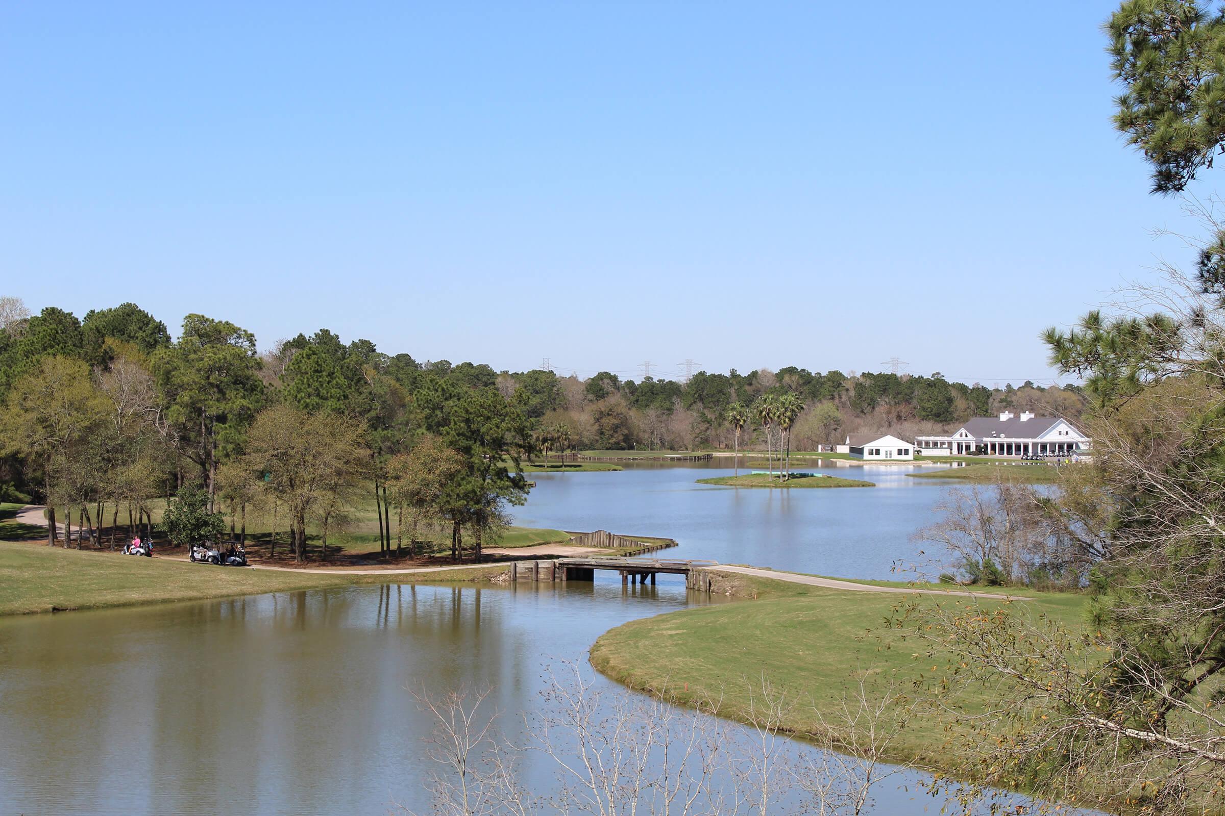 Golf course lake view. Large lake with small bridge spanning for golf carts