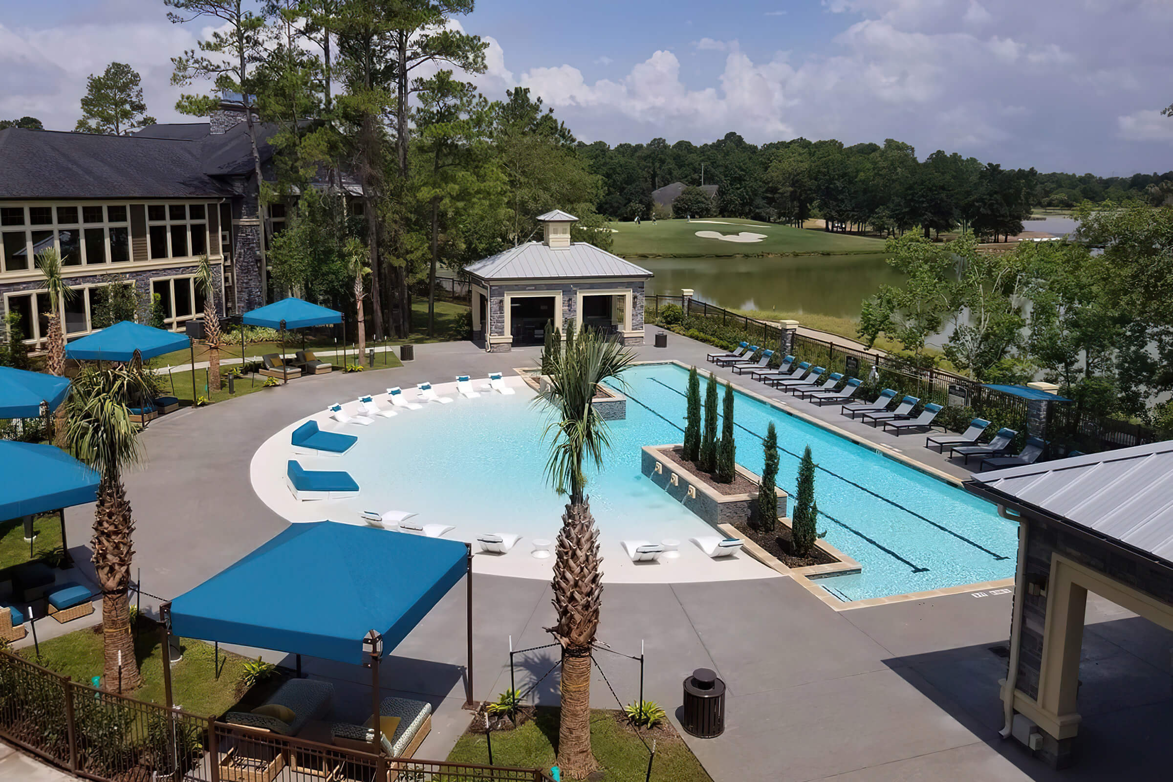 Cabanas around pool with shallow half cirlcle connected to deeper rectangular pool. Golf course view