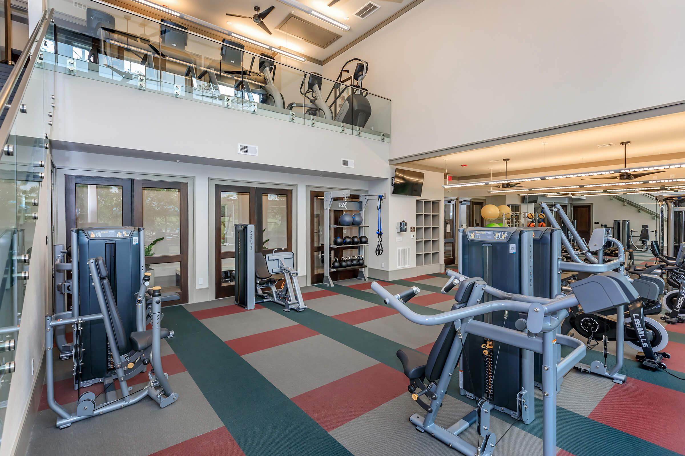2-story state-of-the-art fitness center showing equipment from first floor with second floor visible