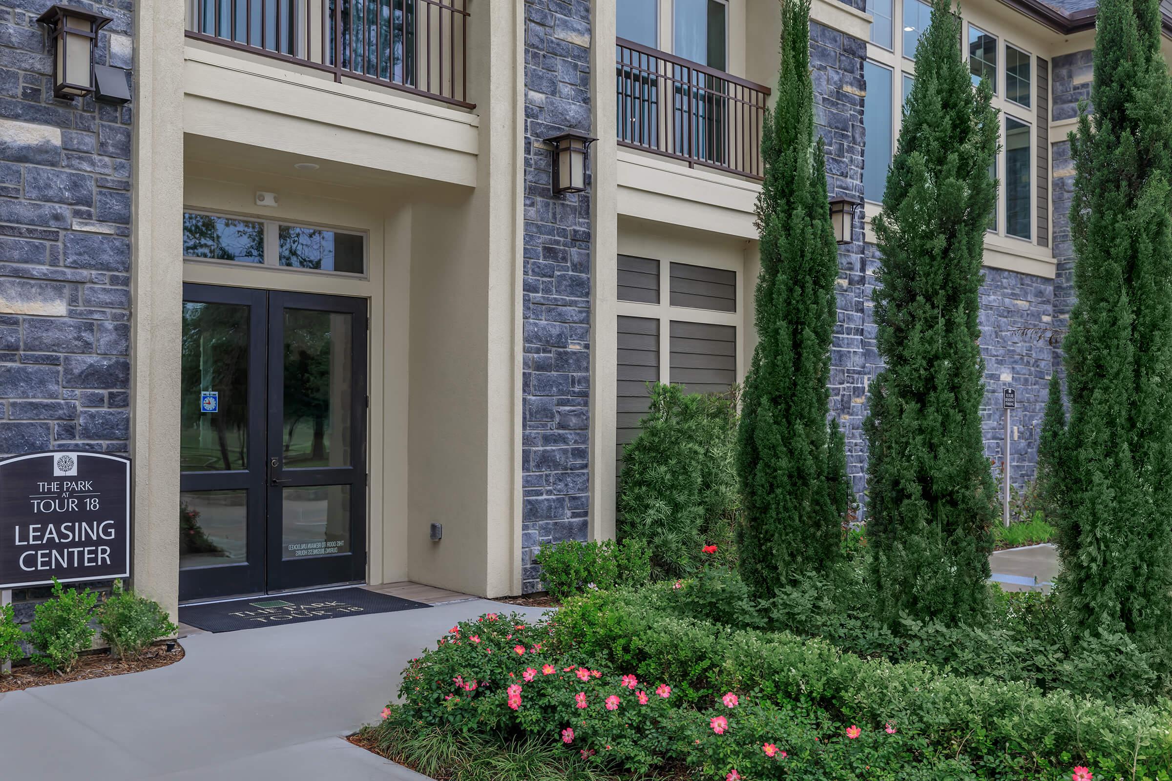 Lush landscaping leading to the exterior of main entrance to Leasing Center.