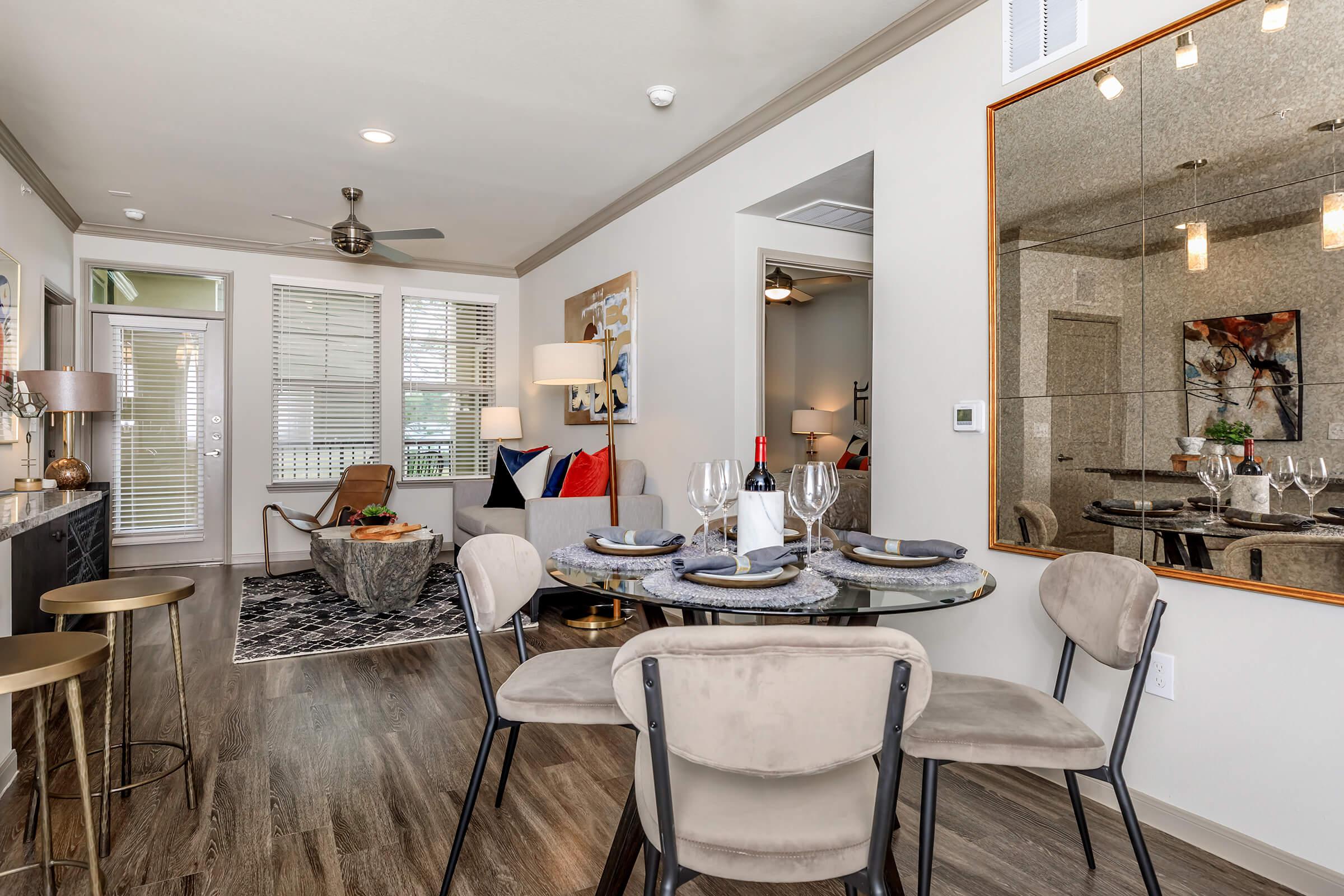 Kitchen table and chairs in the dining area open to living room.