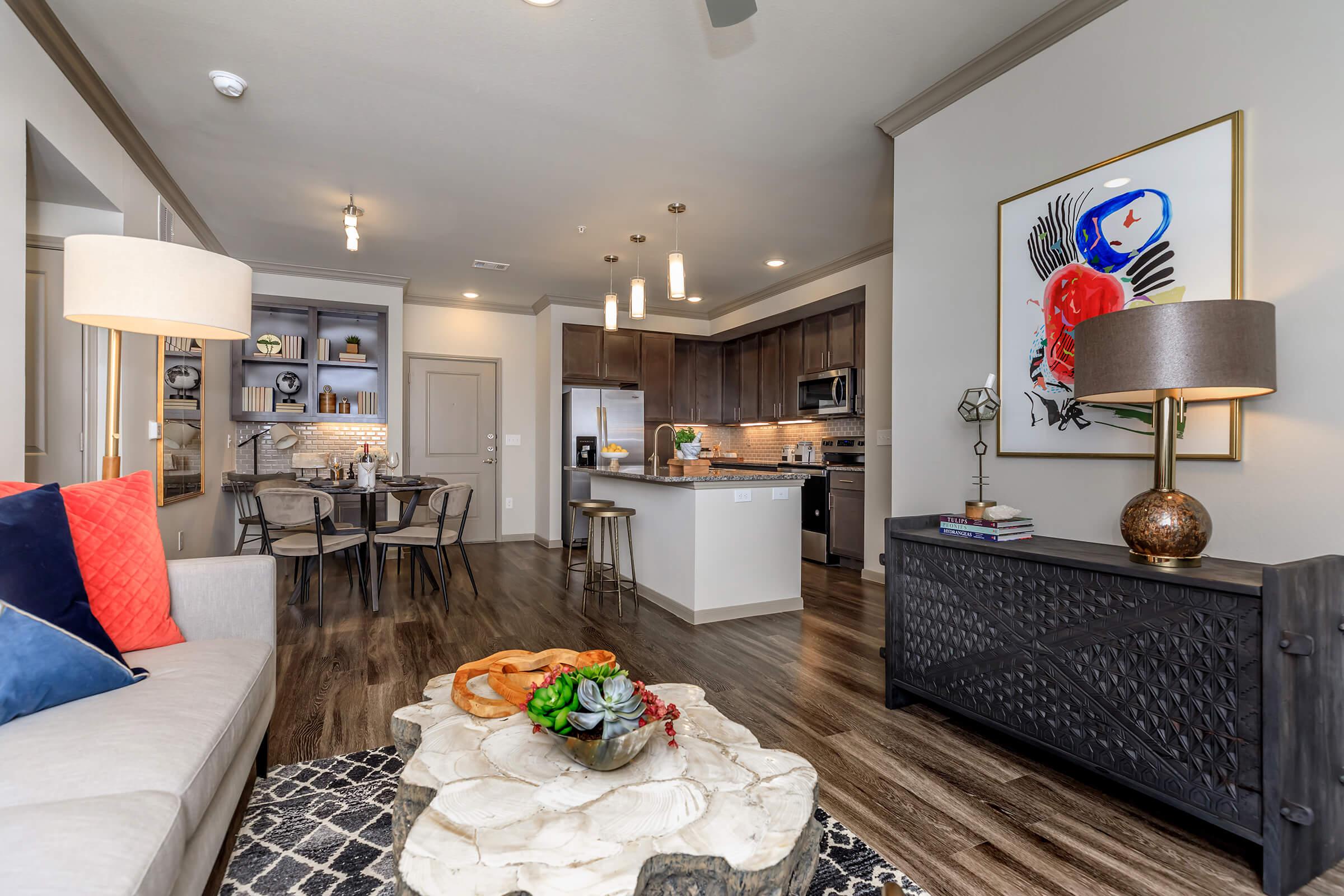 Open view from furnished living area to the dining area and kitchen.