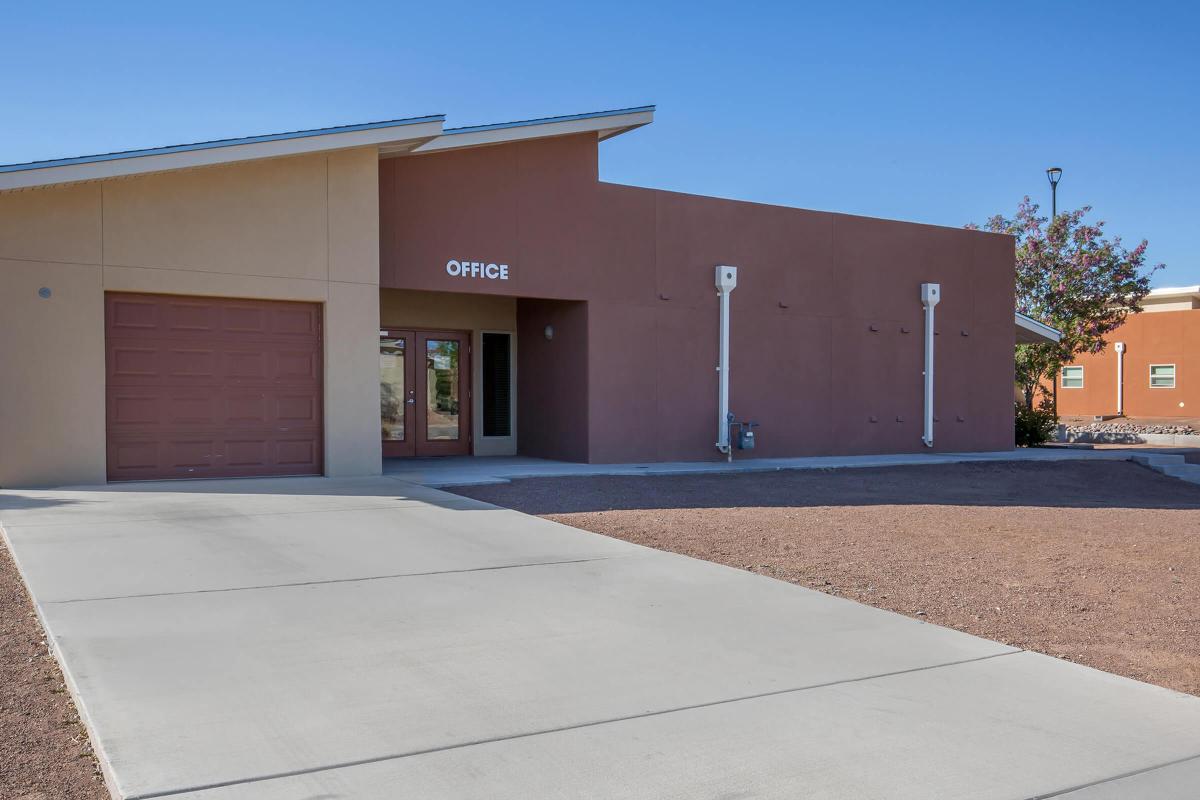 an empty parking lot in front of a brick building