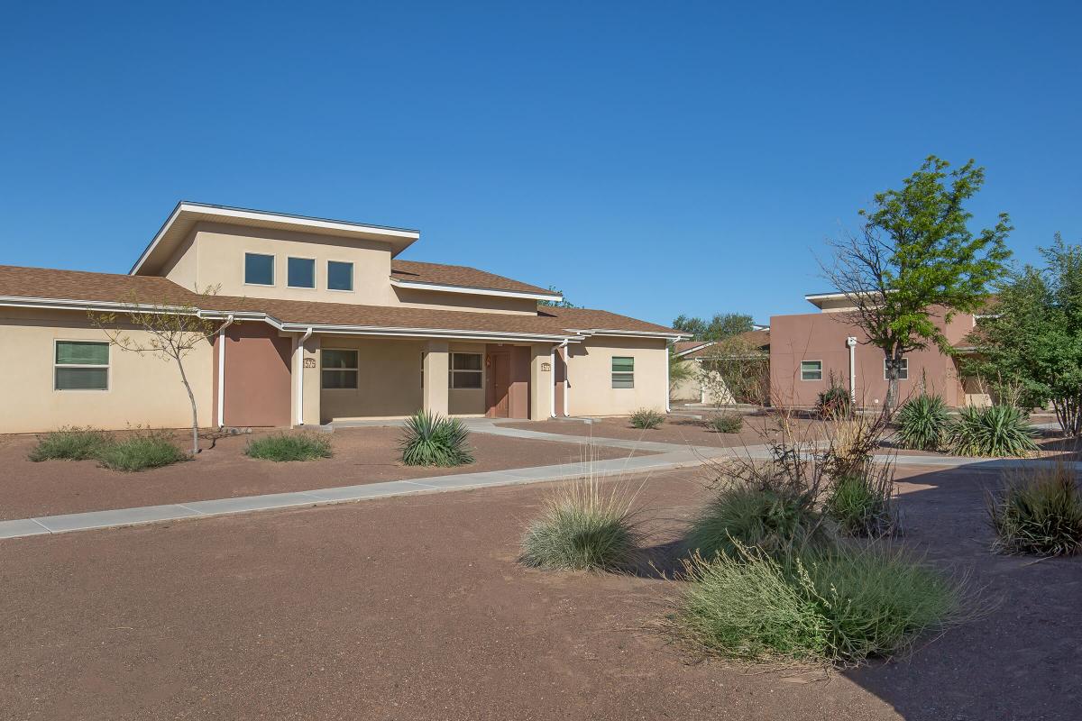 a dirt road in front of a house