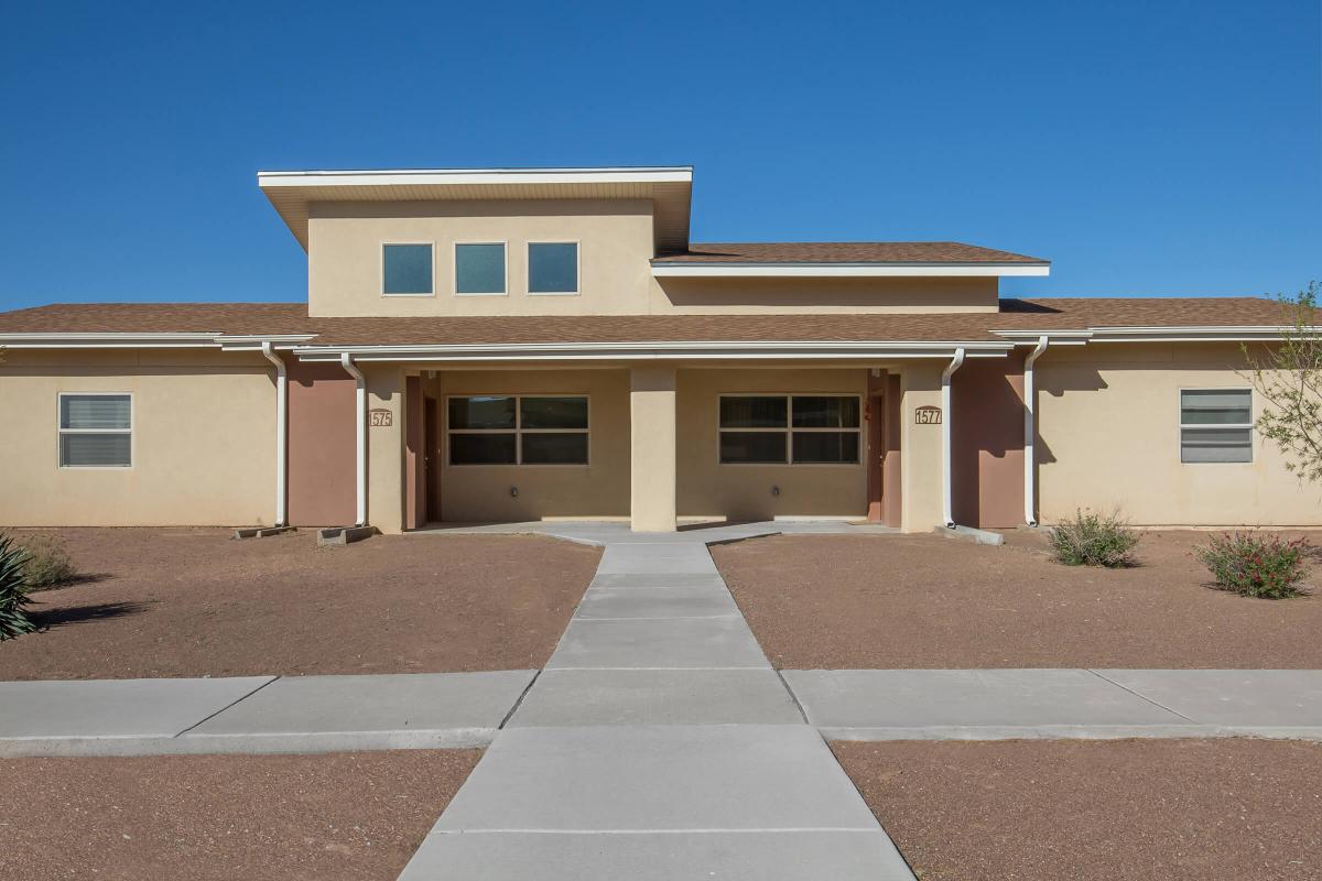 an empty parking lot in front of a house