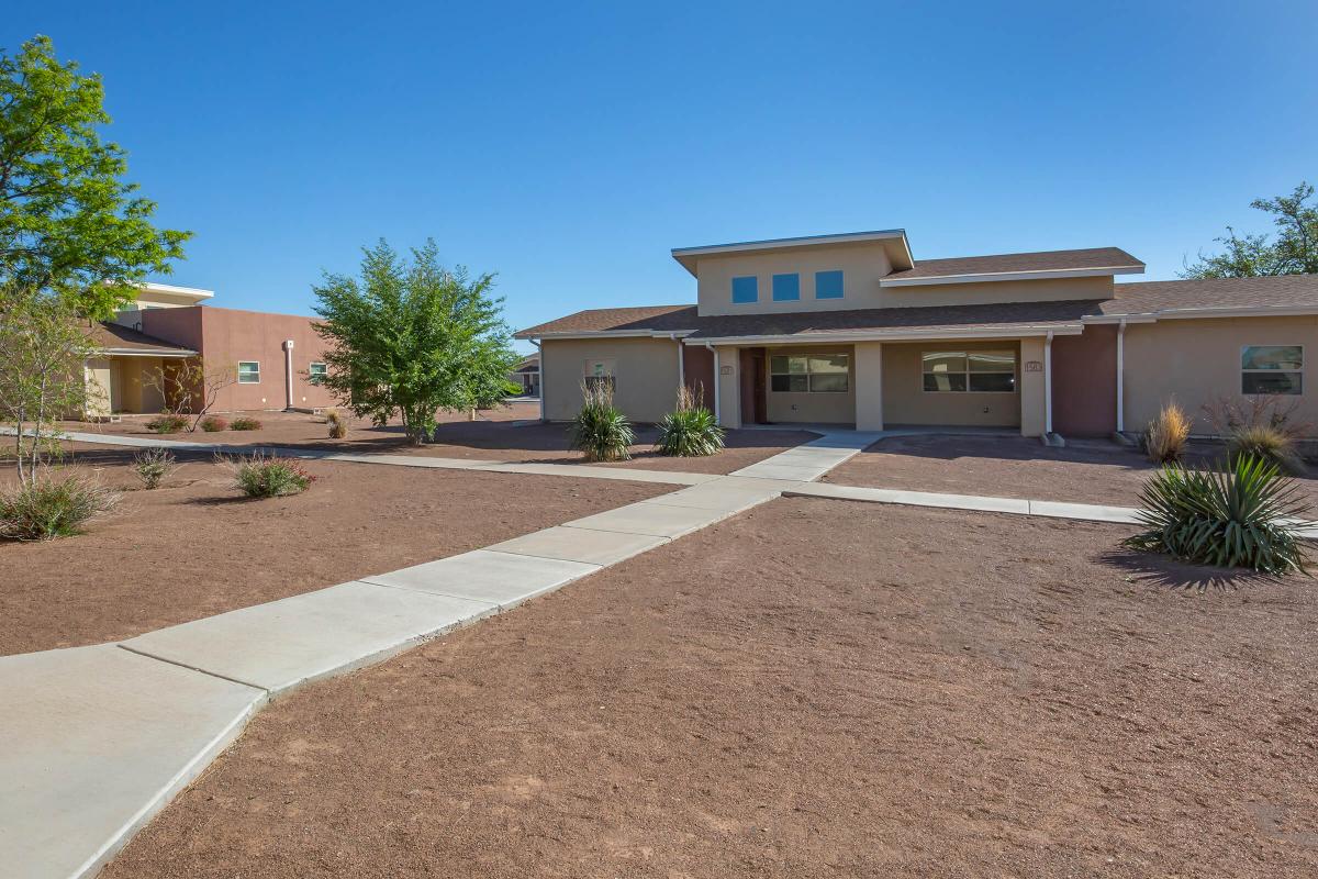 an empty parking lot in front of a house