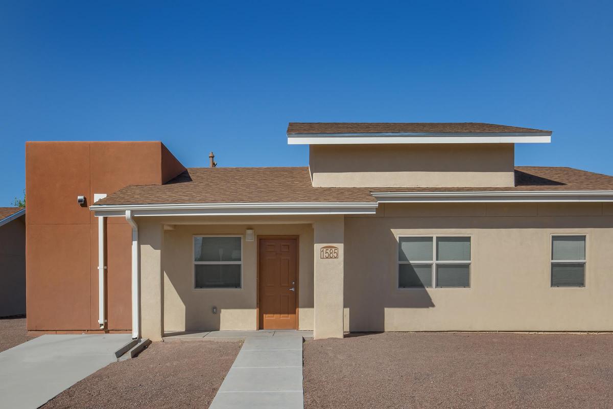 an empty parking lot in front of a house