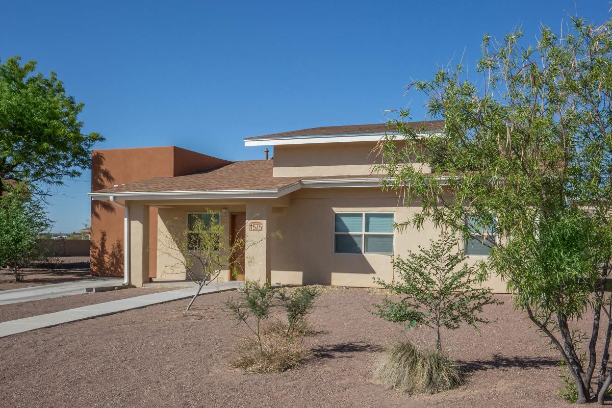 a house with bushes in front of a building