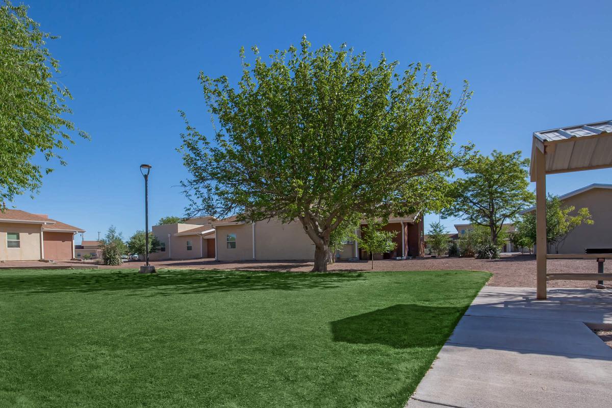 a large brick building with grass and trees