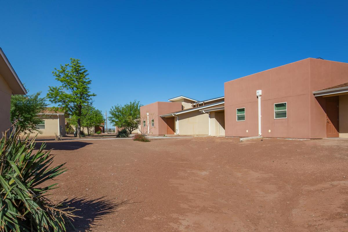 a large brick building with Coral Pink Sand Dunes State Park in the background