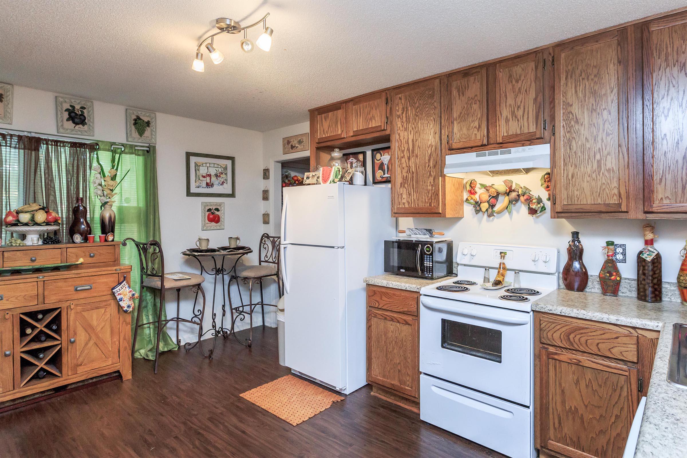 a room filled with furniture and a stove in a kitchen