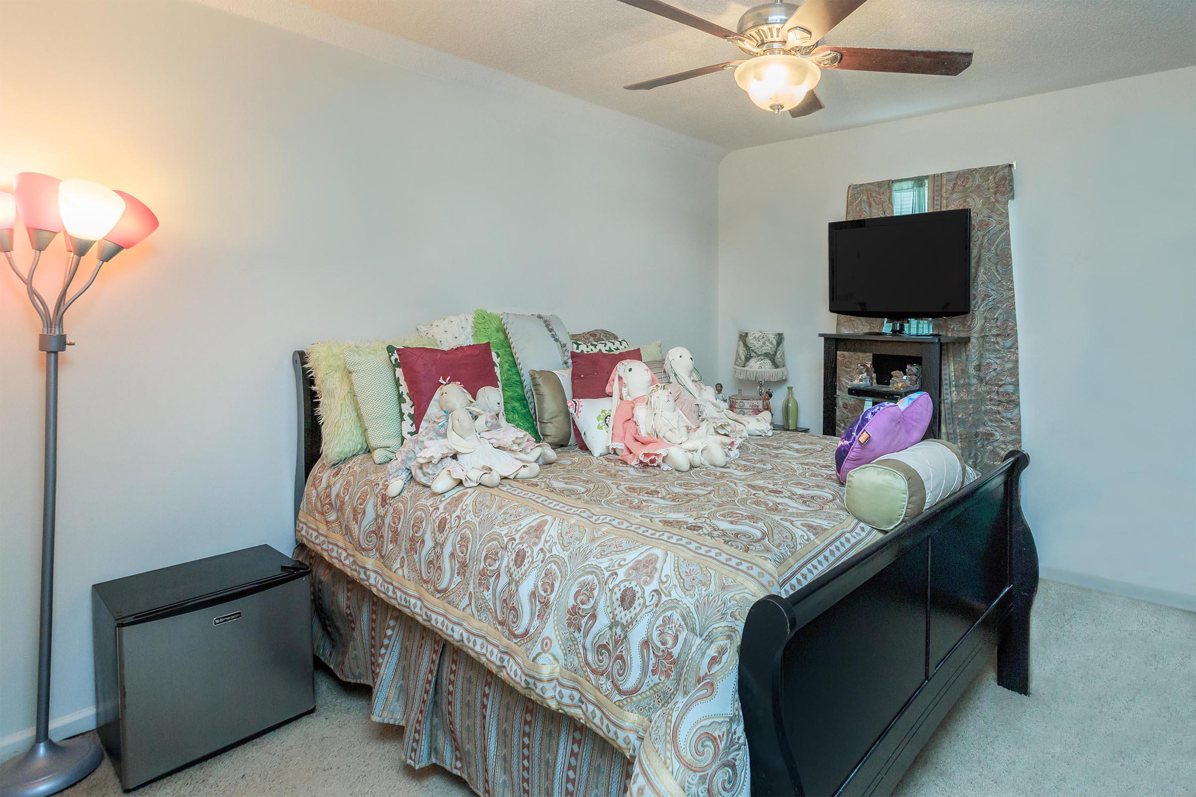 a bedroom with a bed in a room