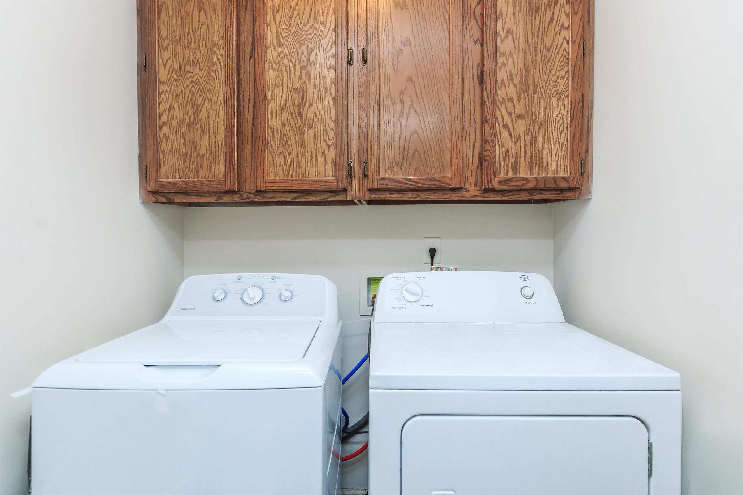 a white microwave oven sitting on top of a refrigerator
